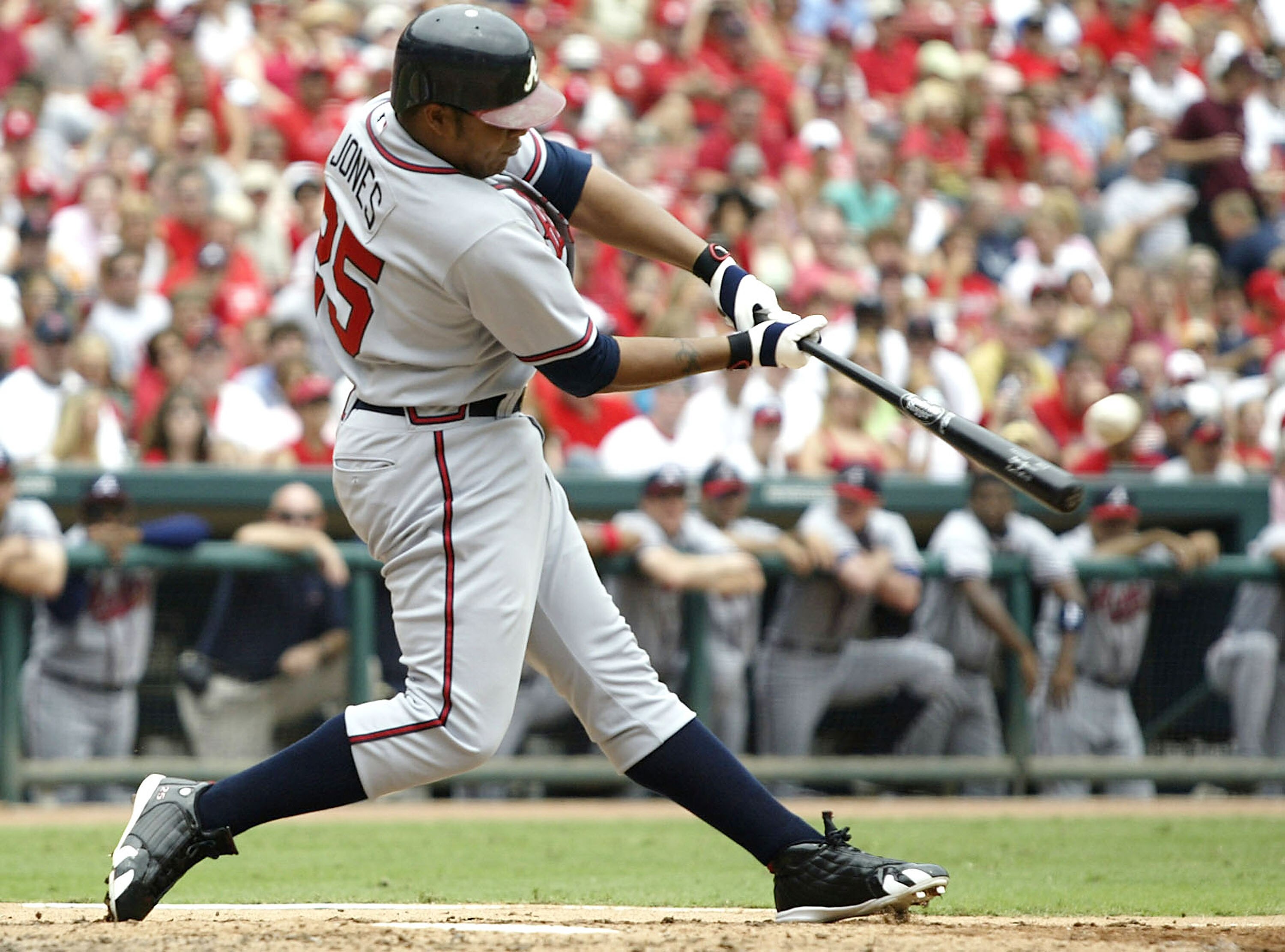 ST. LOUIS - AUGUST 6:  Outfielder Andruw Jones #25 of the Atlanta Braves hits a grand-slam home run against the St. Louis Cardinals on August 6, 2005 at Busch Stadium in St. Louis, Missouri. The Braves defeated the Cardinals 8-1.  (Photo by Dilip Vishwana