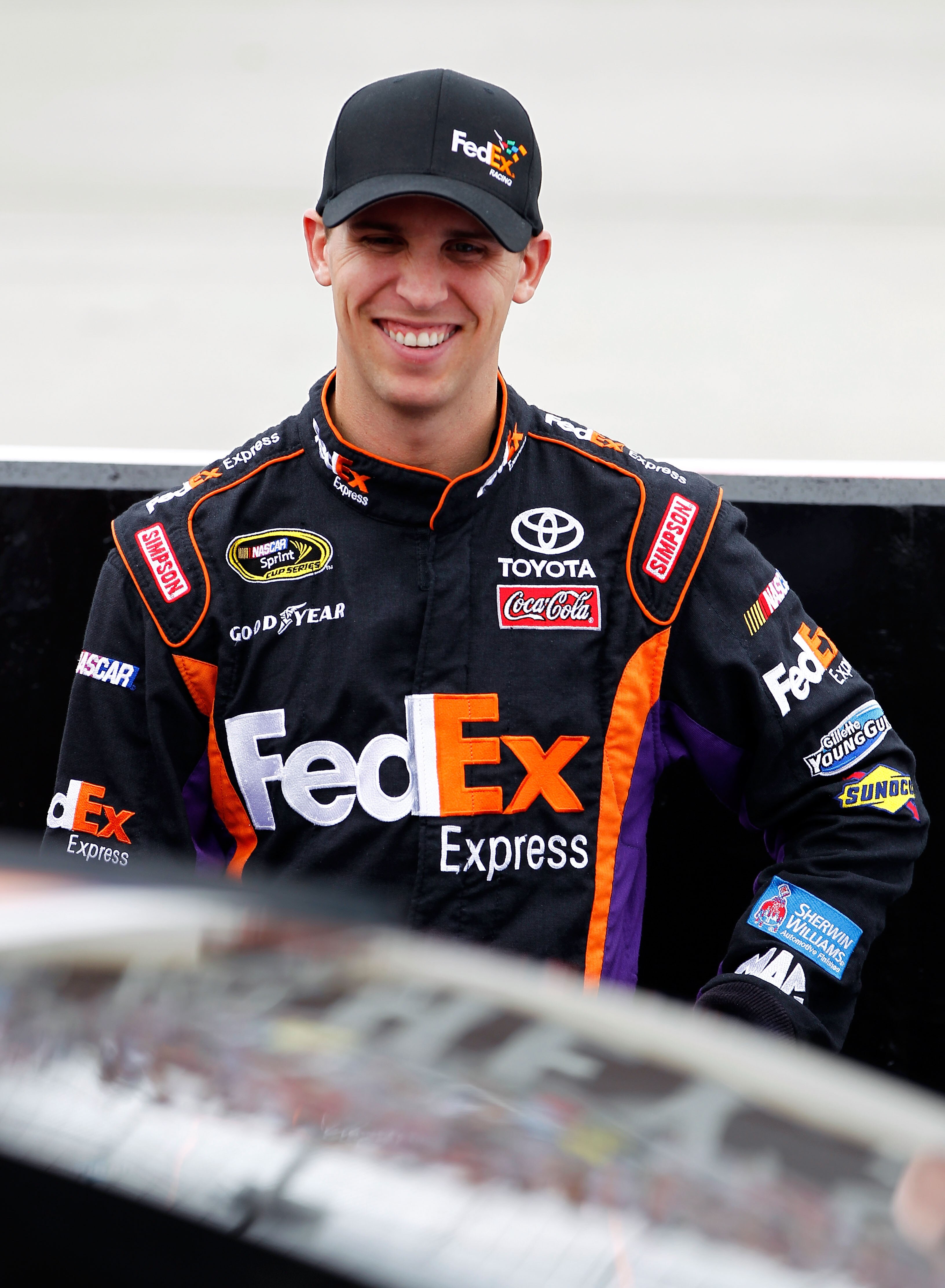 DOVER, DE - SEPTEMBER 26:  Denny Hamlin, driver of the #11 FedEx Express Toyota, stands on the grid prior to the NASCAR Sprint Cup Series AAA 400 at Dover International Speedway on September 26, 2010 in Dover, Delaware.  (Photo by Jeff Zelevansky/Getty Im