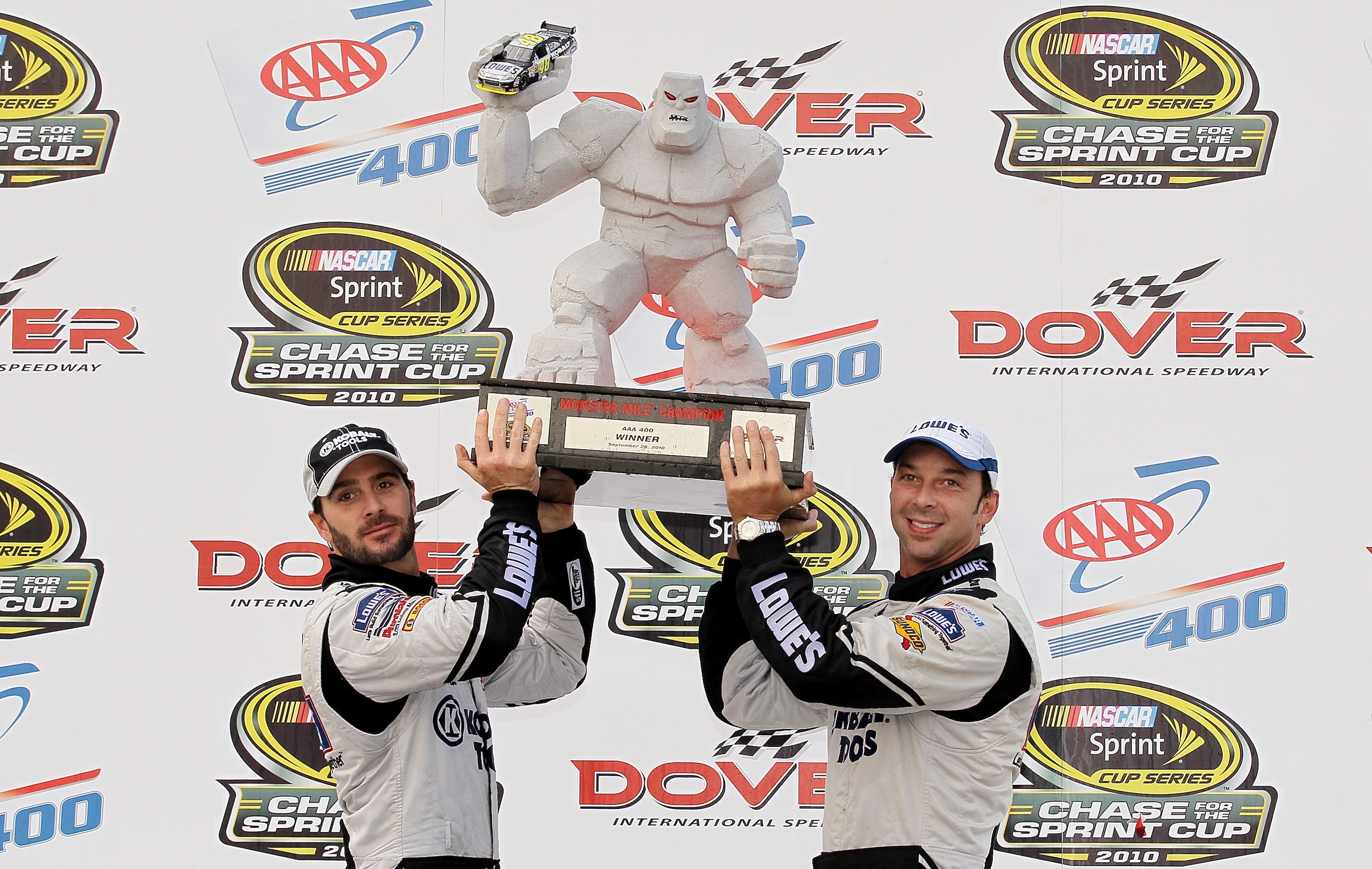 DOVER, DE - SEPTEMBER 26:  Jimmie Johnson (L), driver of the #48 Lowe's Chevrolet, and crew chief Chad Knaus celebrate in Victory Lane after winning the NASCAR Sprint Cup Series AAA 400 at Dover International Speedway on September 26, 2010 in Dover, Delaw