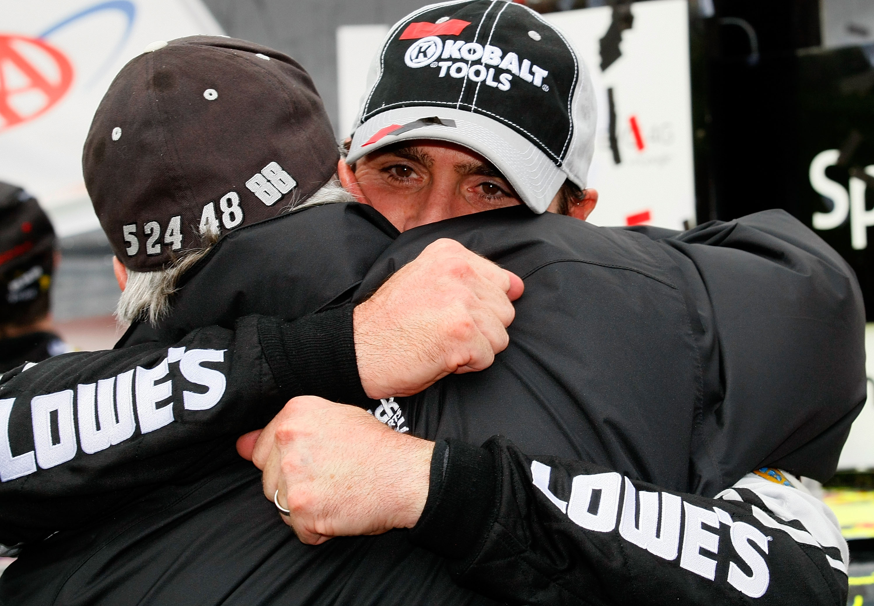 DOVER, DE - SEPTEMBER 26:  Jimmie Johnson (R), driver of the #48 Lowe's Chevrolet, hugs team owner Rick Hendrick in Victory Lane after winning the NASCAR Sprint Cup Series AAA 400 at Dover International Speedway on September 26, 2010 in Dover, Delaware.