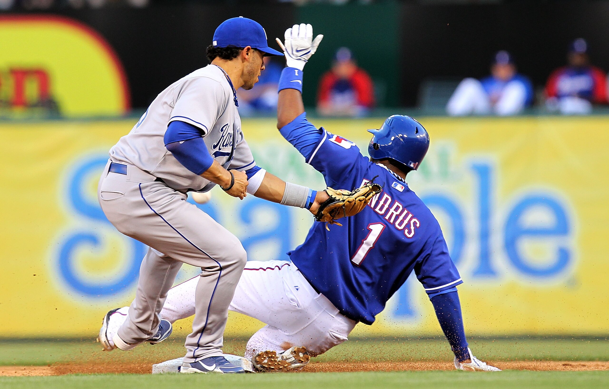 ARLINGTON, TX - MAY 06:  Elvis Andrus #1 of the Texas Rangers safely steals second base against Mike Aviles #30 of the Kansas City Royals on May 6, 2010 at the Ballpark in Arlington, Texas.  (Photo by Ronald Martinez/Getty Images)