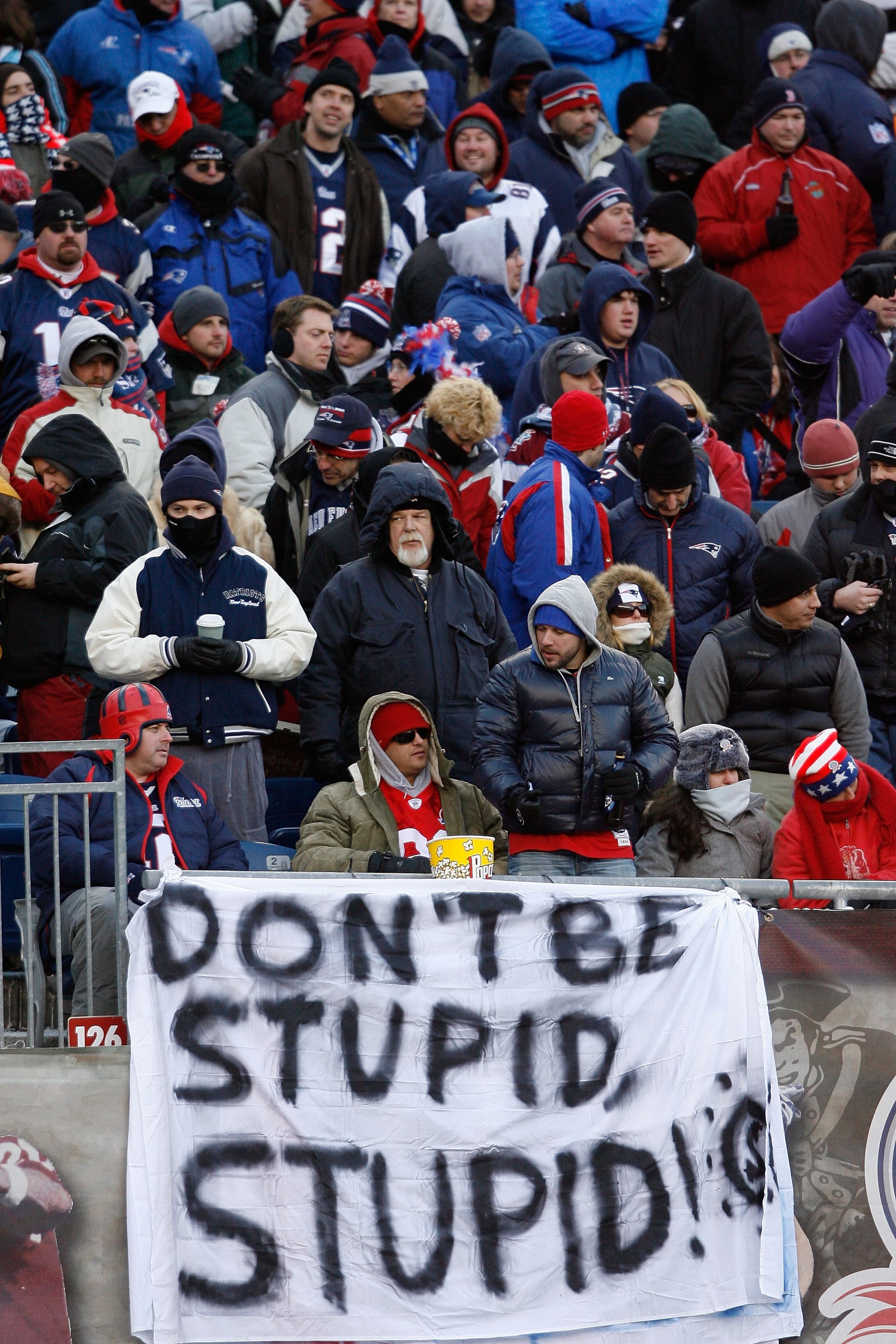 FOXBORO, MA - JANUARY 10:  Fans of the New England Patriots hang a sign which reads 'Don't Be Stupid, Stupid!' against the Baltimore Ravens during the 2010 AFC wild-card playoff game at Gillette Stadium on January 10, 2010 in Foxboro, Massachusetts.  (Pho