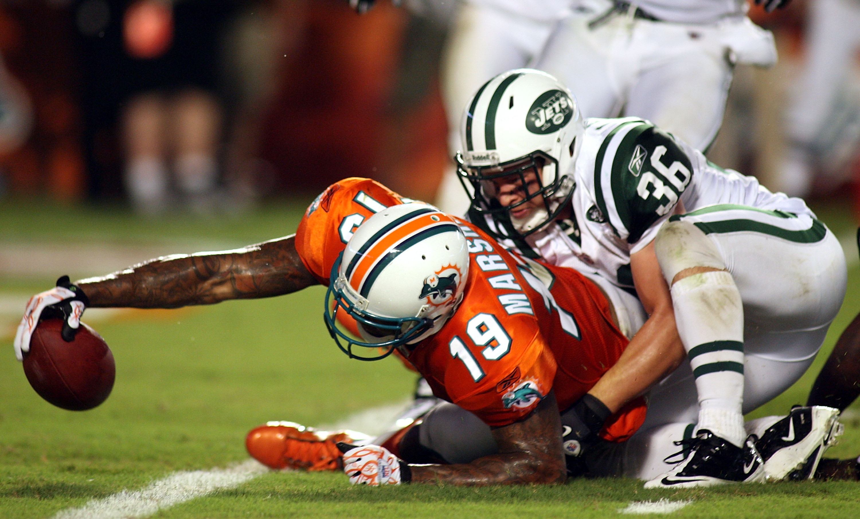 MIAMI - SEPTEMBER 26:  Receiver Brandon Marshall #19 of the Miami Dolphins scores a touchdown against the New York Jets at Sun Life Stadium on September 26, 2010 in Miami, Florida.  (Photo by Marc Serota/Getty Images)