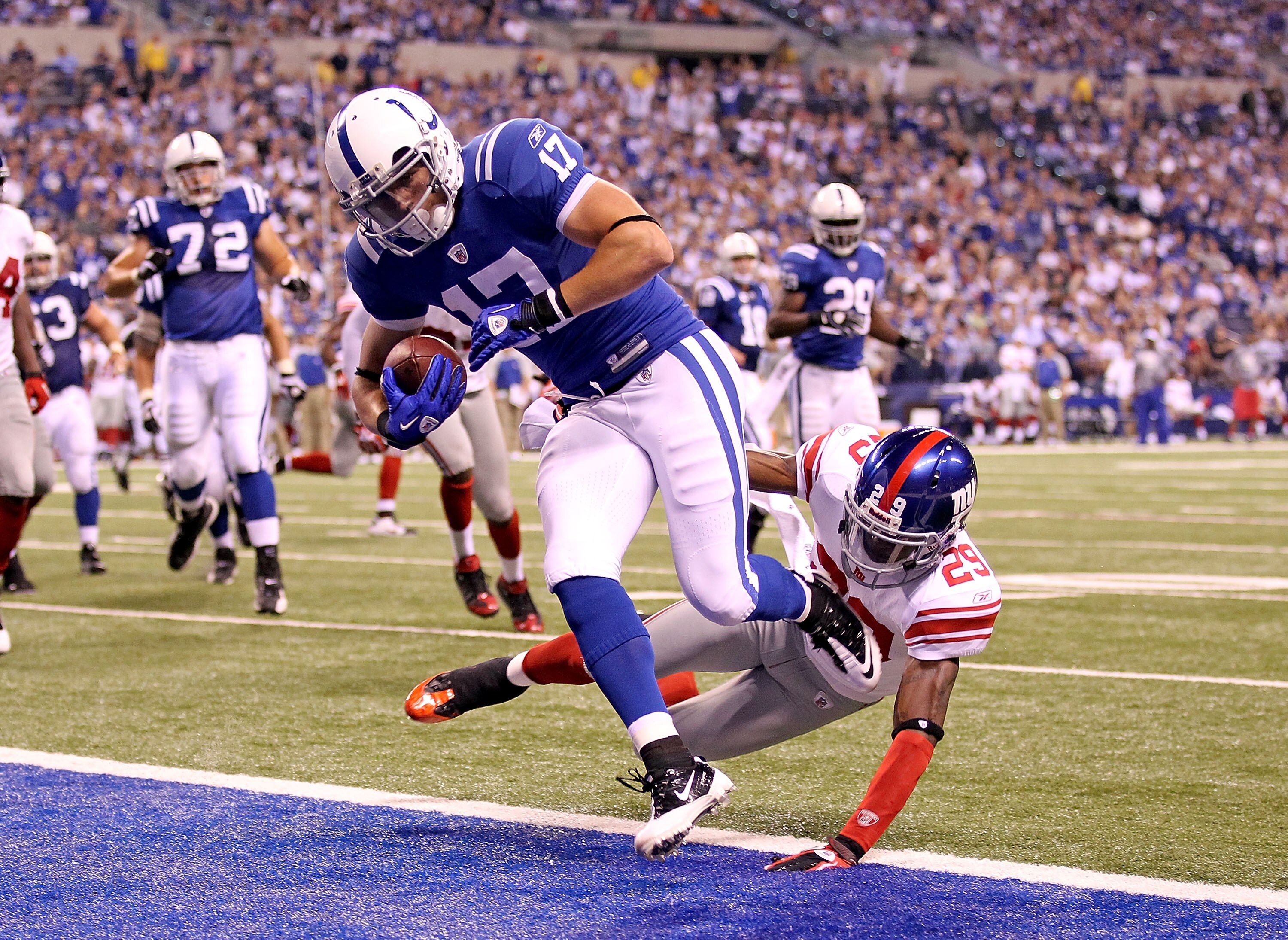 INDIANAPOLIS - SEPTEMBER 19: Austin Collie #17  of the Indianapolis Colts scores a touchdown while defended by D.J. Johnson #29 of the New York Giants during the NFL game at Lucas Oil Stadium on September 19, 2010 in Indianapolis, Indiana.  (Photo by Andy