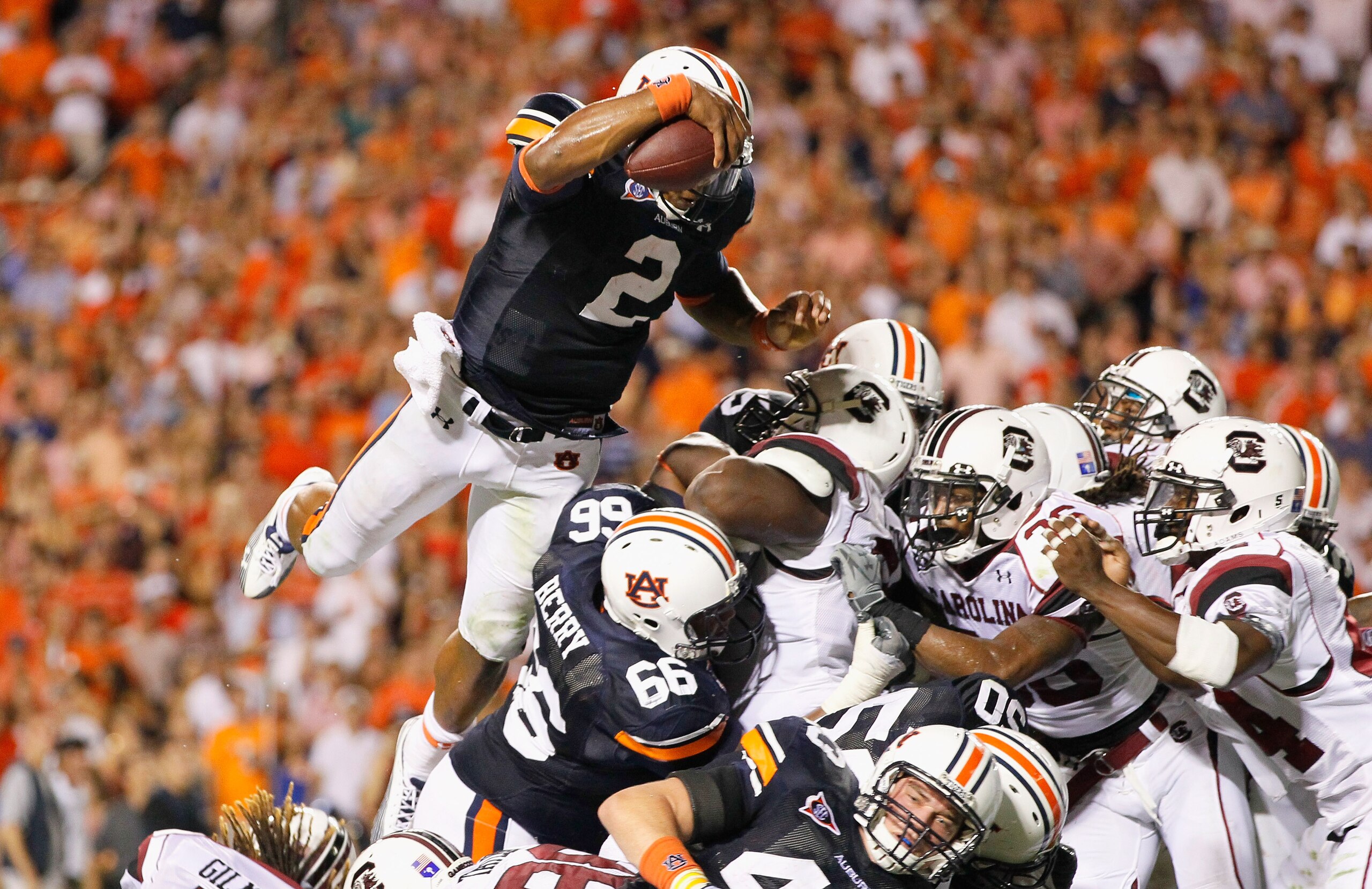 AUBURN, AL - SEPTEMBER 25:  Quarterback Cameron Newton #2 of the Auburn Tigers dives across the offensive and defensive lines for a touchdown against the South Carolina Gamecocks before it was called back for a false start at Jordan-Hare Stadium on Septem