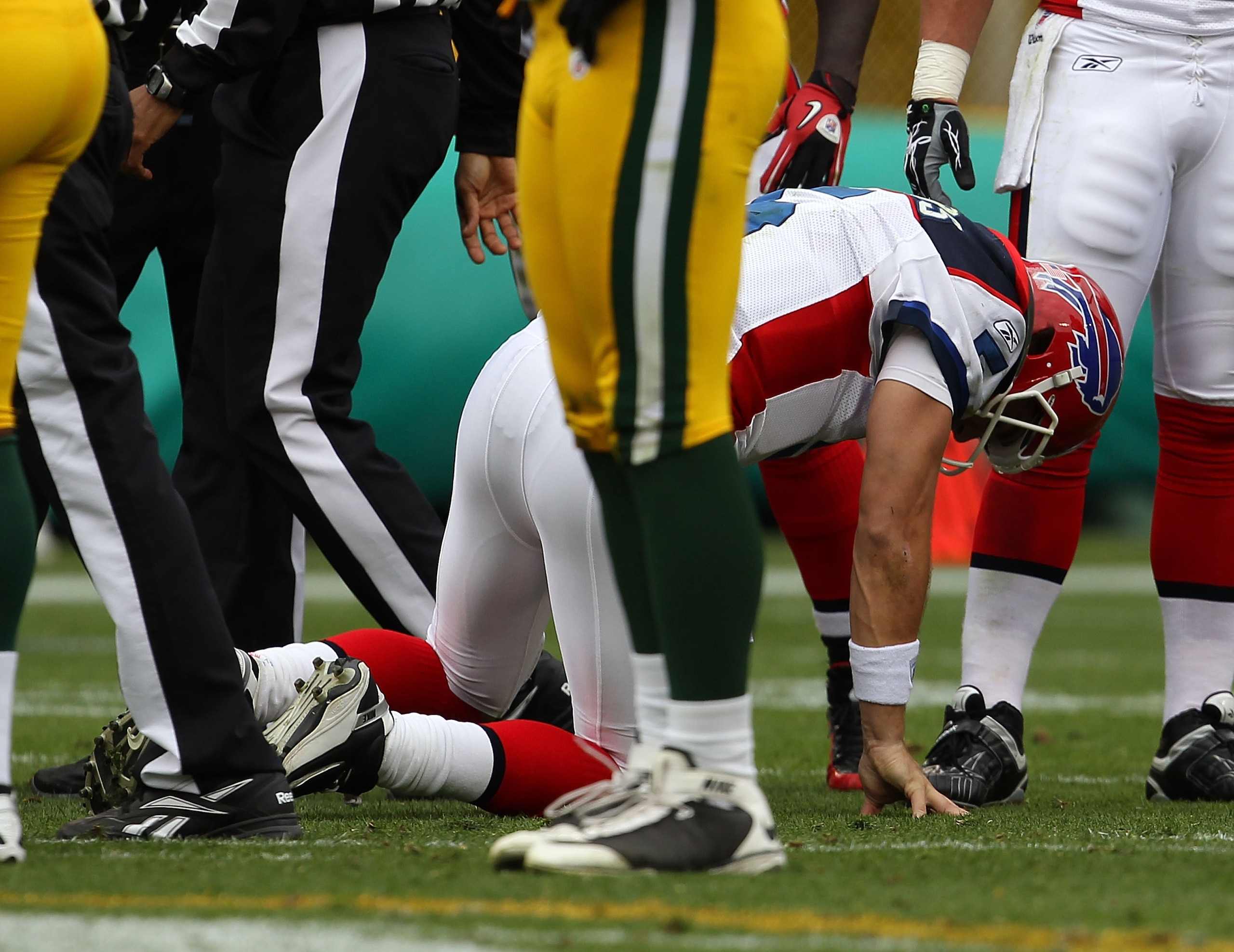 GREEN BAY, WI - SEPTEMBER 19: Trent Edwards #5 of the Buffalo Bills has trouble getting up after being sacked by members of the Green Bay Packer defense at Lambeau Field on September 19, 2010 in Green Bay, Wisconsin. The Packers defeated the Bills 34-7.