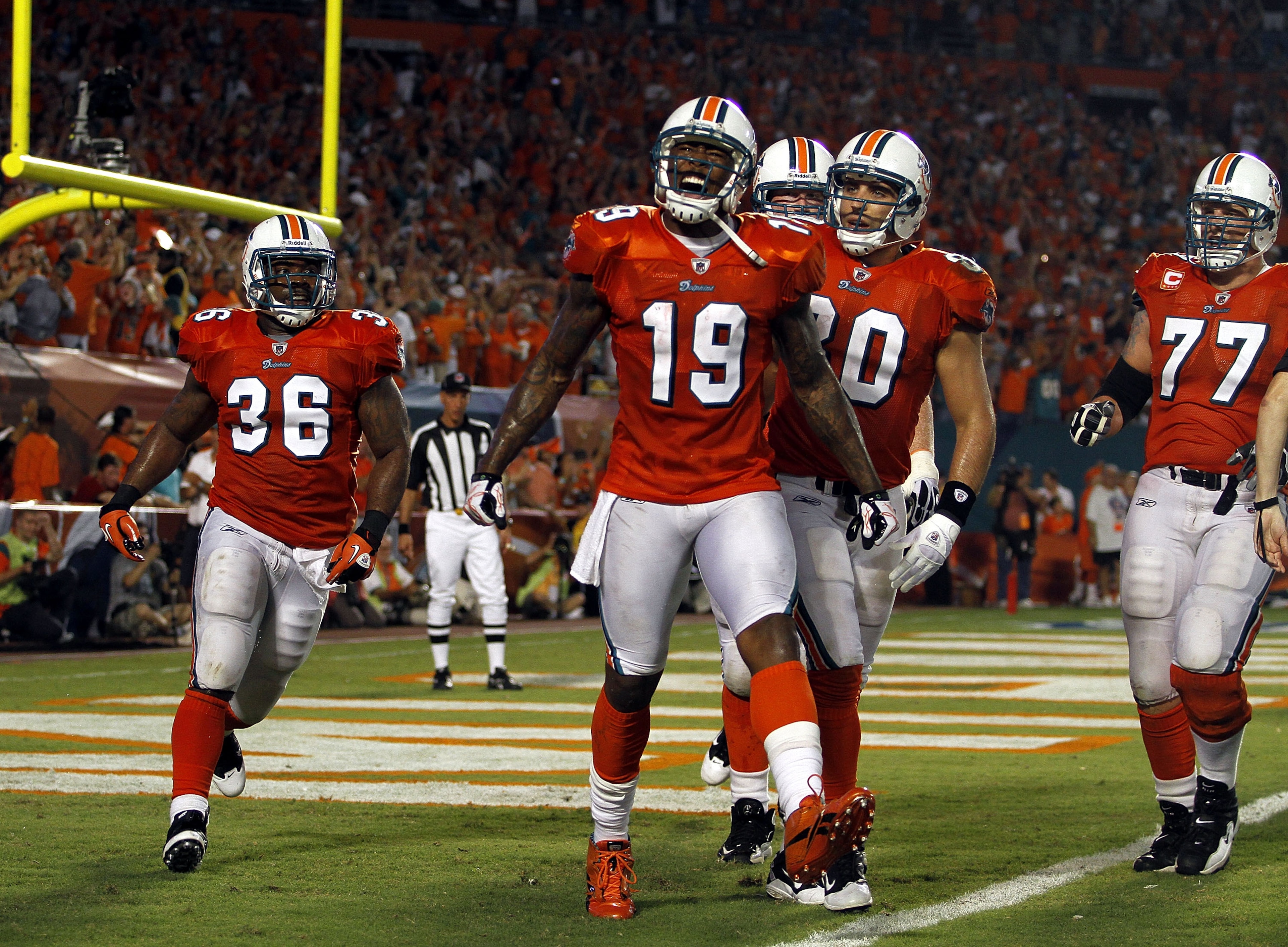 MIAMI - SEPTEMBER 26:  Receiver Brandon Marshall #19 of the Miami Dolphins celebrates a touchdown against the New York Jets at Sun Life Stadium on September 26, 2010 in Miami, Florida.  (Photo by Marc Serota/Getty Images)