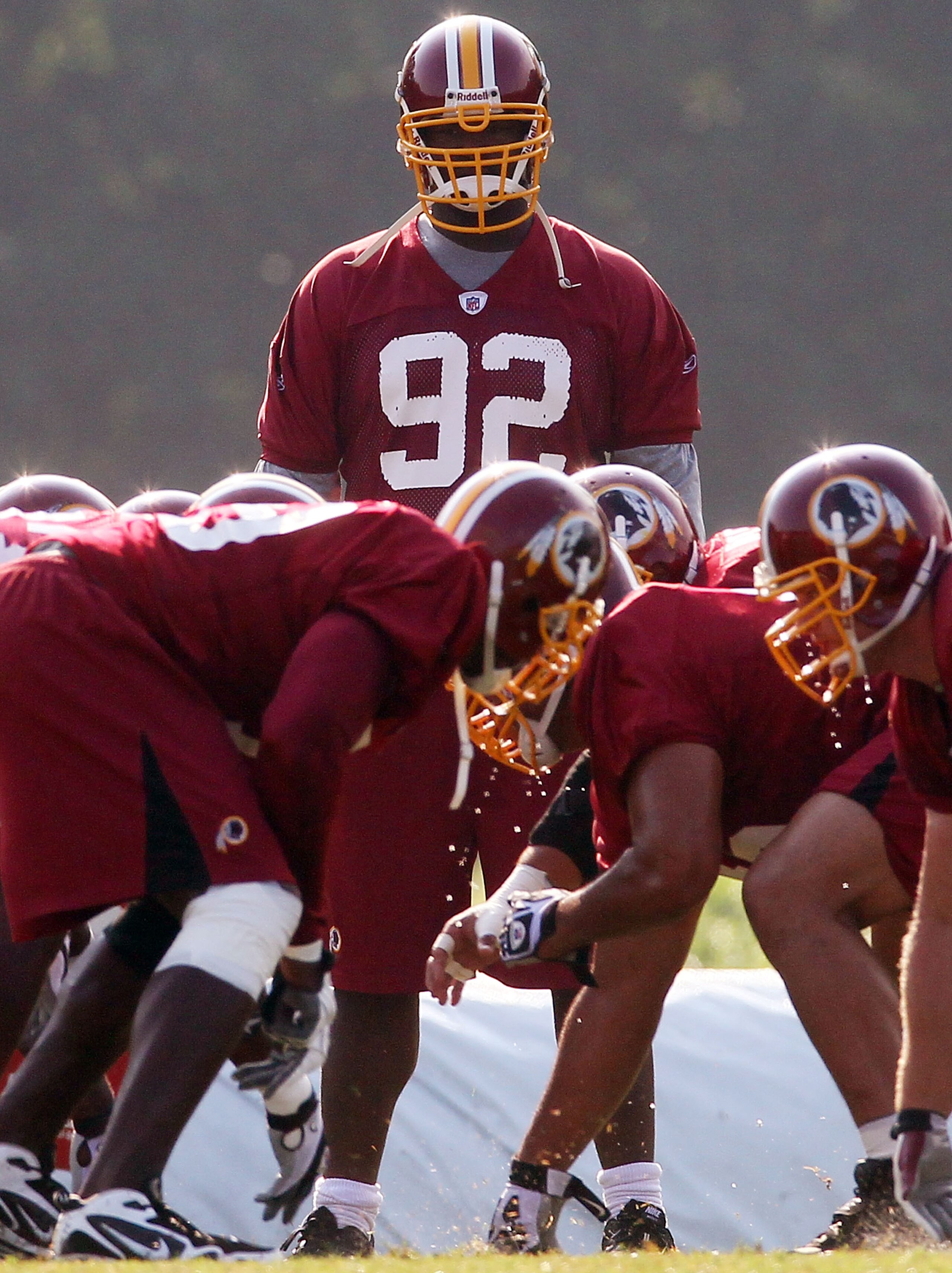 ASHBURN, VA - AUGUST 06:  Defensive lineman #92 of the Washington Redskins watches his teamates practice as he sits out his eighth consecutive day of practice during Redskins training camp on August 6, 2010 in Ashburn, Virginia.  (Photo by Win McNamee/Get