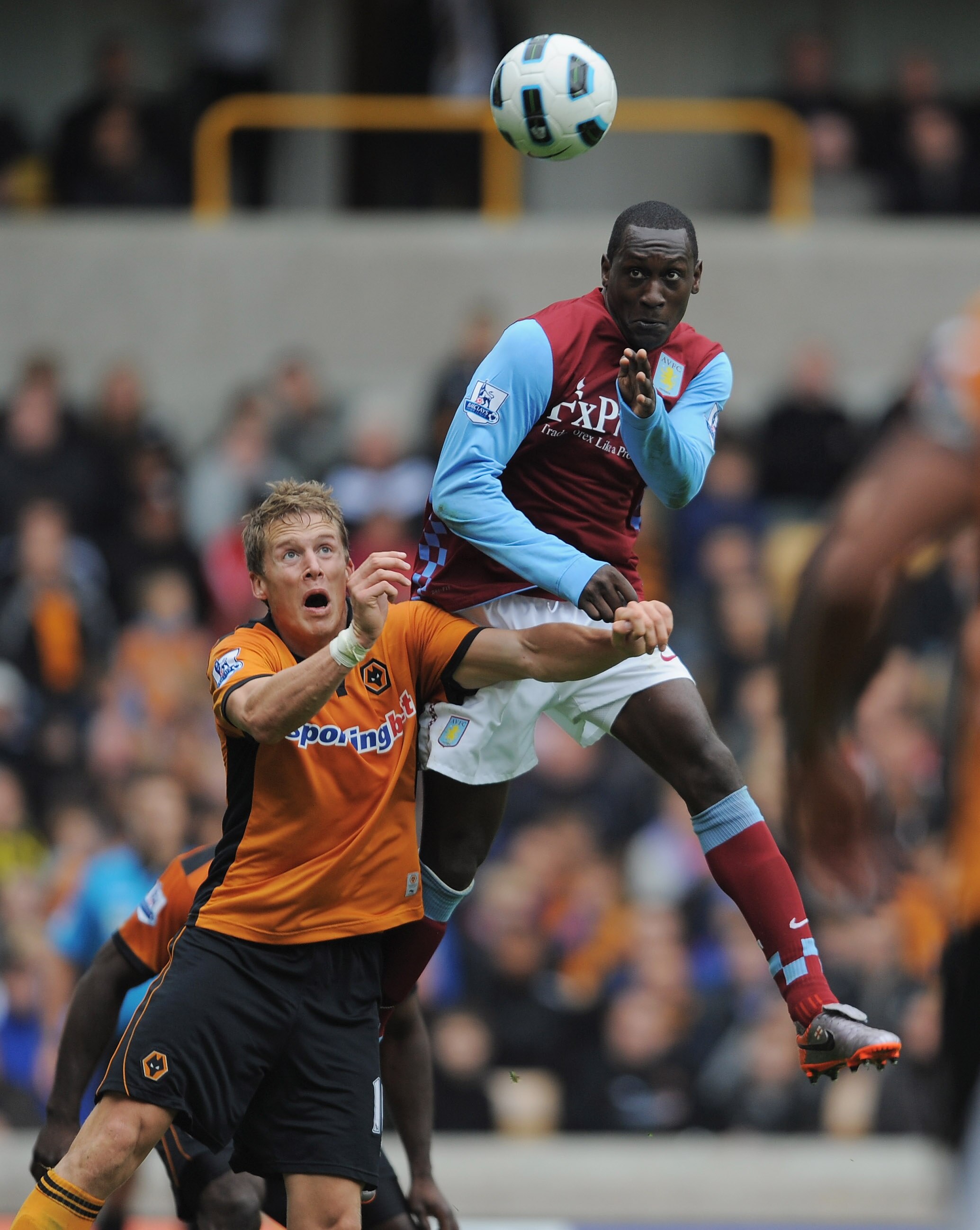 WOLVERHAMPTON, ENGLAND - SEPTEMBER 26: Emile Heskey of Aston Villa outjumps Christophe Berra of Wolves to score to make it 2-1 during the Barclays Premier League match between Wolverhampton Wanderers and Aston Villa at Molineux on September 26, 2010 in Wo