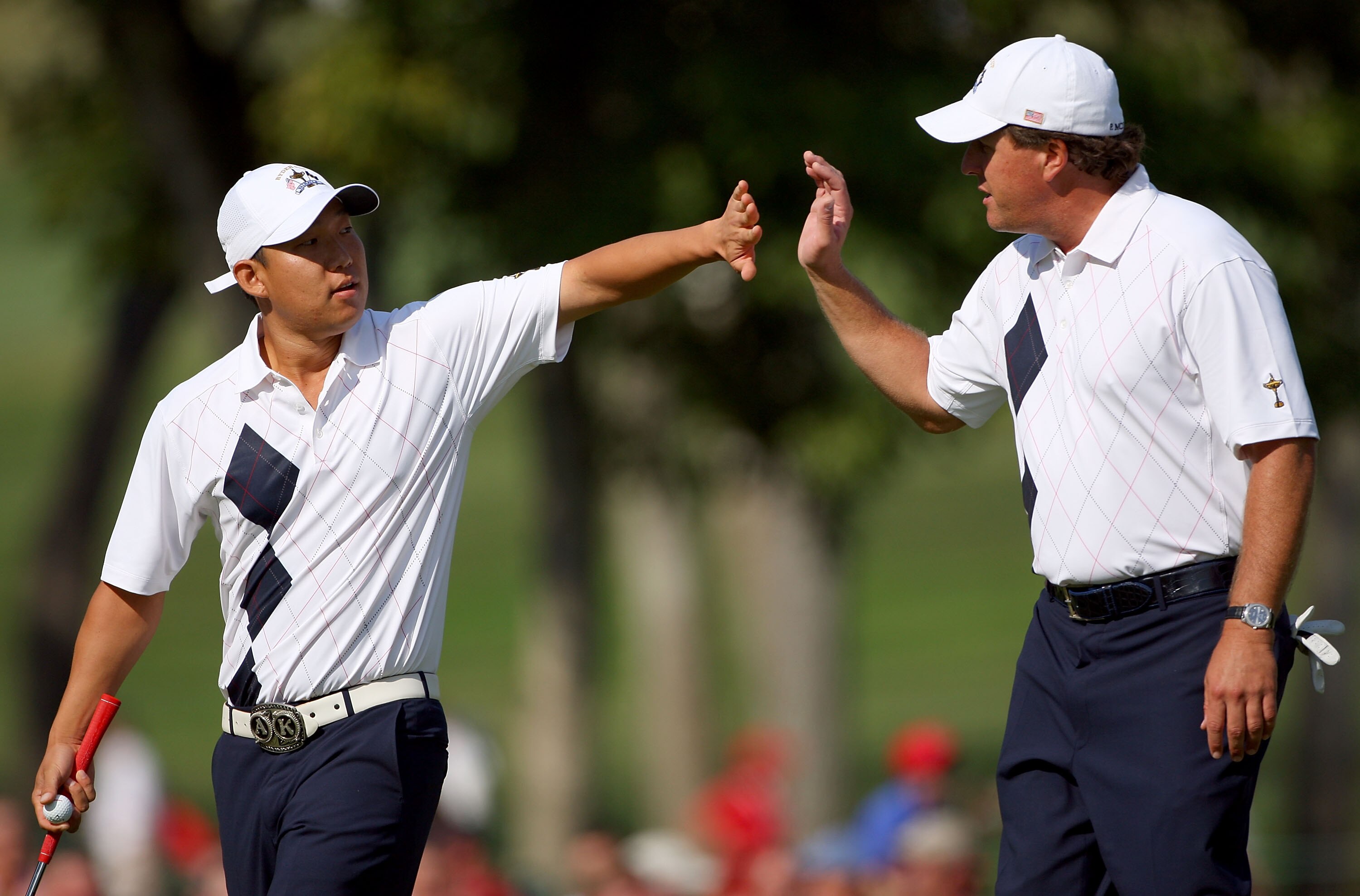 LOUISVILLE, KY - SEPTEMBER 19:  Anthony Kim and Phil Mickelson of the USA team celebrate on the 14th green during the morning foursomes on day one of the 2008 Ryder Cup at Valhalla Golf Club on September 19, 2008 in Louisville, Kentucky.  (Photo by Andrew