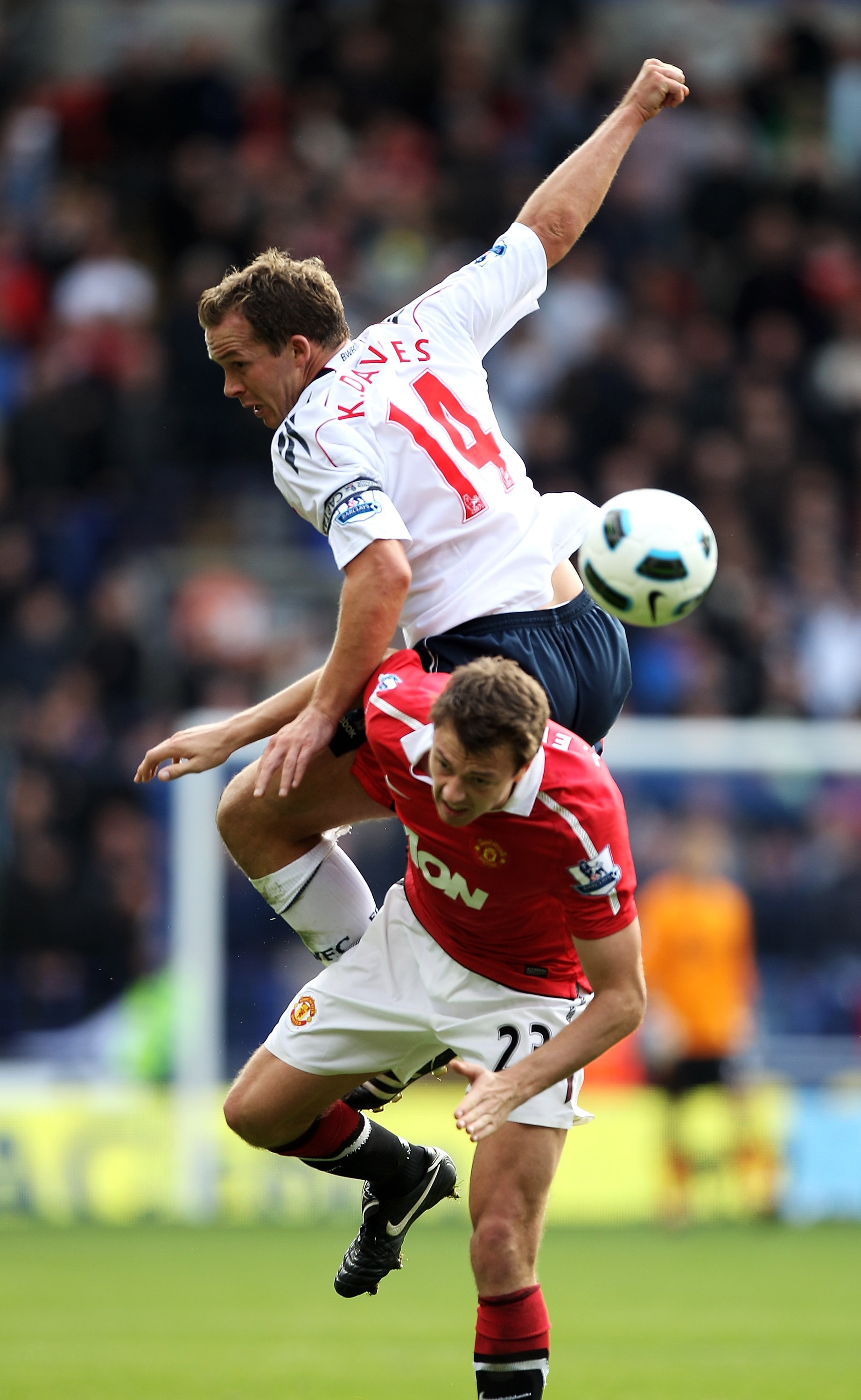 BOLTON, ENGLAND - SEPTEMBER 26:  Kevin Davies of Bolton Wanderers tangles with Jonny Evans of Manchester United during the Barclays Premier League match between Bolton Wanderers and Manchester United at the Reebok Stadium on September 26, 2010 in Bolton, 