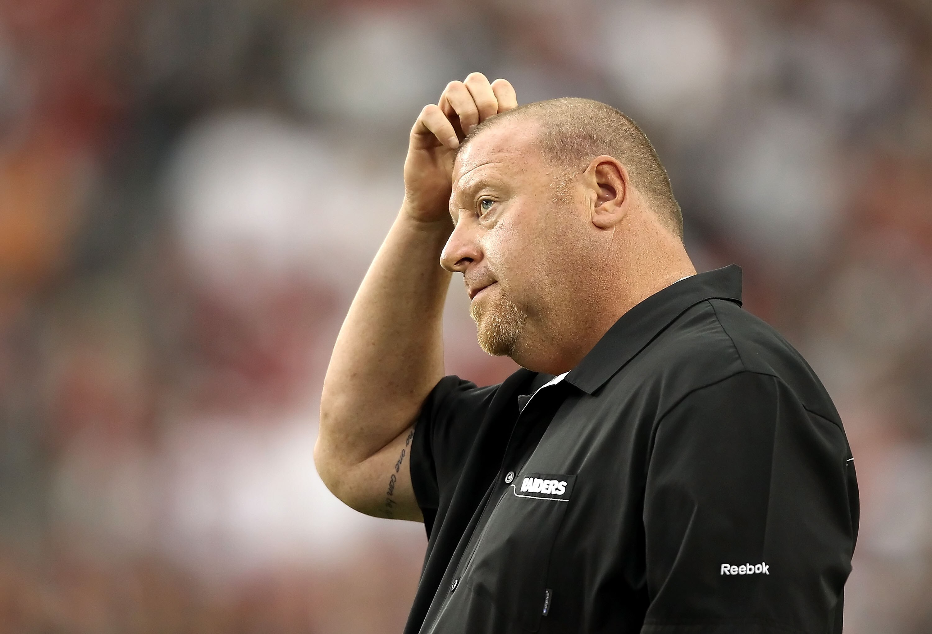 GLENDALE, AZ - SEPTEMBER 26:  Head coach Tom Cable of the Oakland Raiders scratches his head as he stands on the sidelines during the fourth quarter of the NFL game against the Arizona Cardinals at the University of Phoenix Stadium on September 26, 2010 i