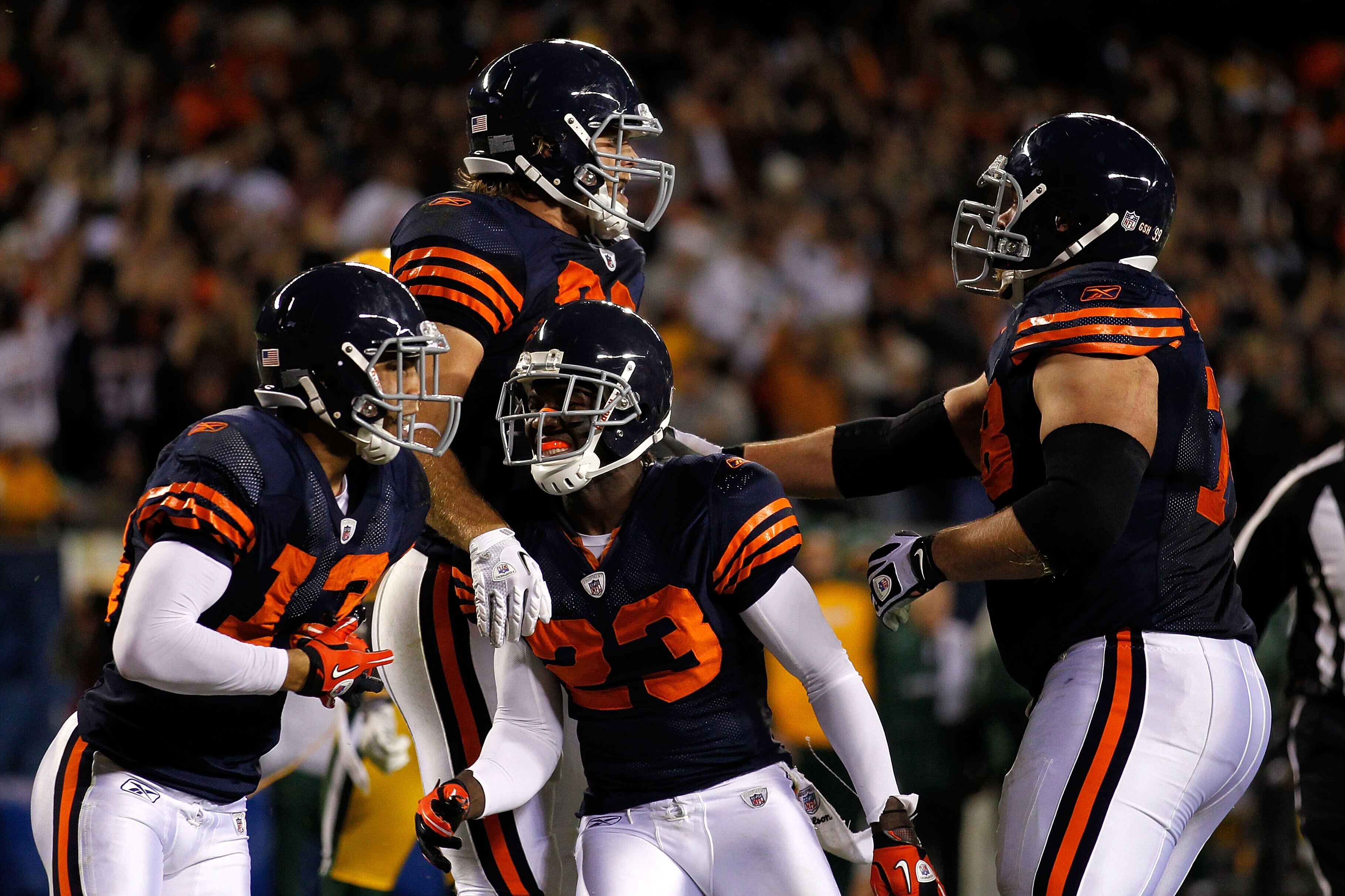 CHICAGO - SEPTEMBER 27:  (L-R) Johnny Knox, Greg Olsen #82, Devin Hester #23 and Kevin Shaffer #78 of the Chicago Bears celebrate after Olsen scored a  9-yard touchdown in the second quarter against the Green Bay Packers at Soldier Field on September 27,