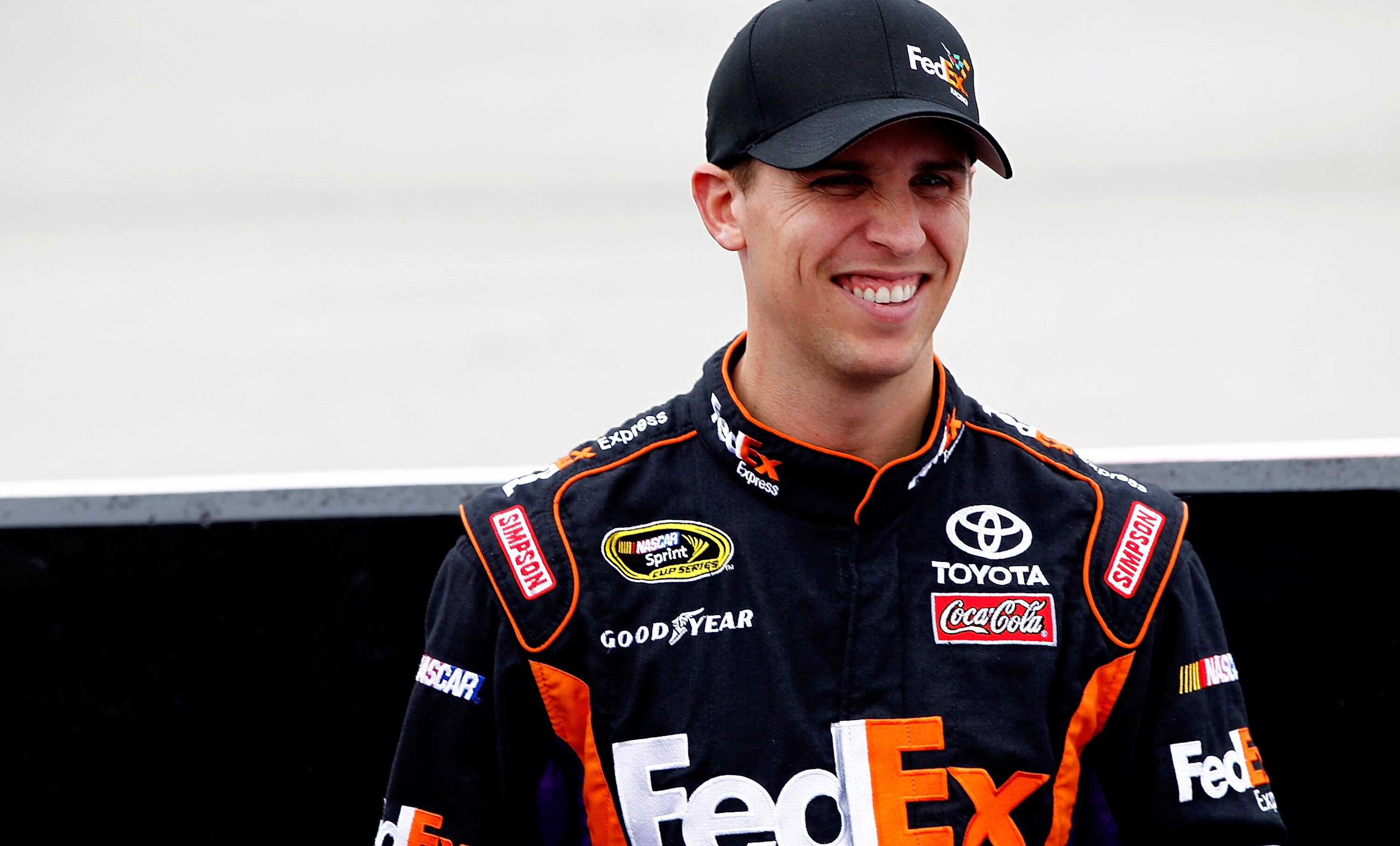 DOVER, DE - SEPTEMBER 26:  Denny Hamlin, driver of the #11 FedEx Express Toyota, stands on the grid prior to the NASCAR Sprint Cup Series AAA 400 at Dover International Speedway on September 26, 2010 in Dover, Delaware.  (Photo by Jeff Zelevansky/Getty Im