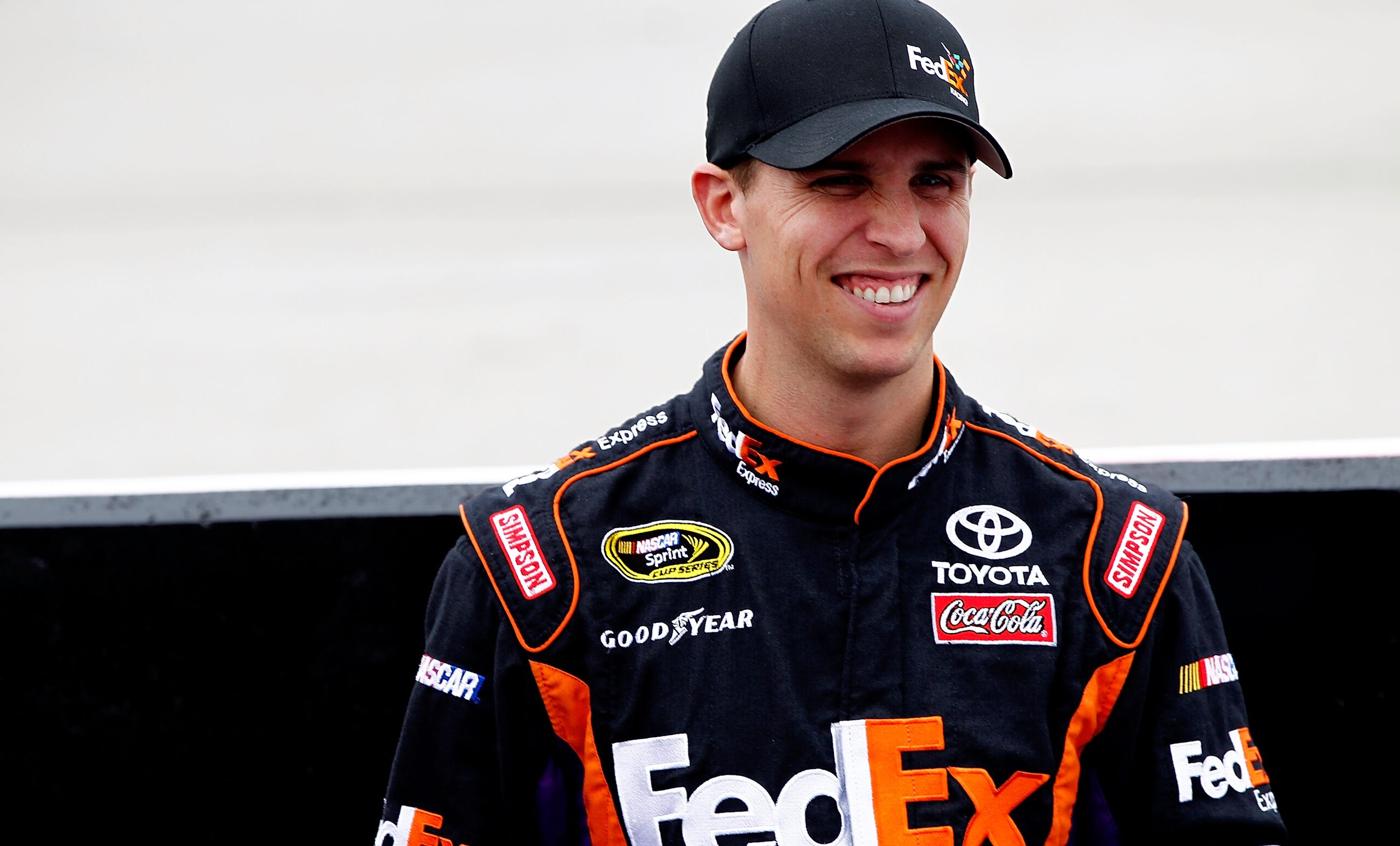 DOVER, DE - SEPTEMBER 26:  Denny Hamlin, driver of the #11 FedEx Express Toyota, stands on the grid prior to the NASCAR Sprint Cup Series AAA 400 at Dover International Speedway on September 26, 2010 in Dover, Delaware.  (Photo by Jeff Zelevansky/Getty Im