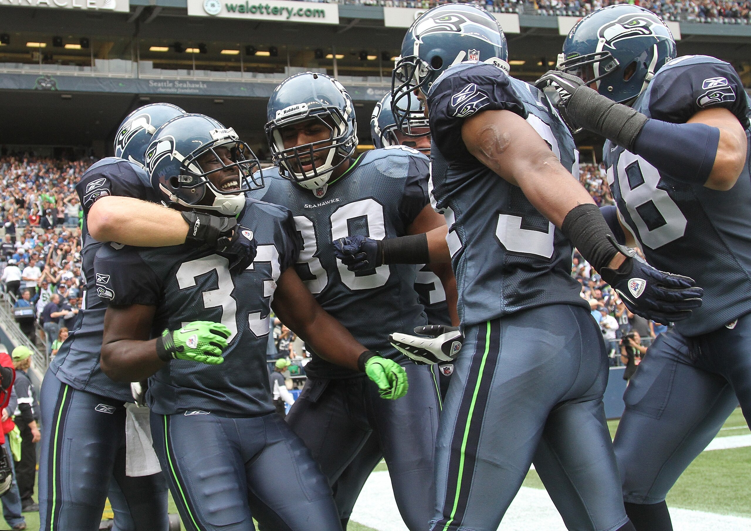 SEATTLE - SEPTEMBER 26:  Kick returner Leon Washington #33 of the Seattle Seahawks celebrates with teammates after scoring a touchdown on a 101 yard kickoff return in the third quarter against the San Diego Chargers at Qwest Field on September 26, 2010 in