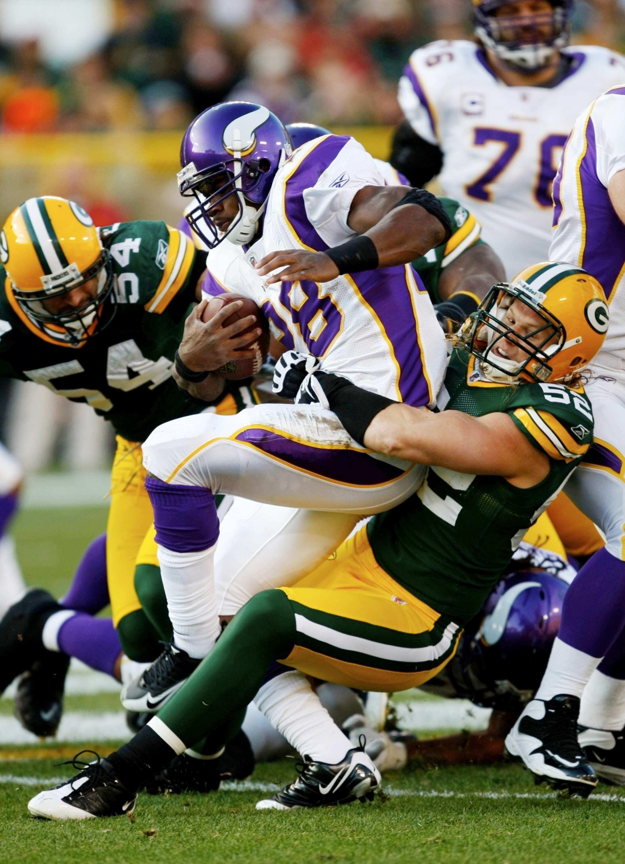 GREEN BAY, WI - NOVEMBER 01:  Clay Matthews #52 of the Green Bay Packers tackles Adrian Peterson #28 of the Minnesota Vikings during the first quarter of the game at Lambeau Field on November 1, 2009 in Green Bay, Wisconsin. (Photo by Scott Boehm/Getty Im