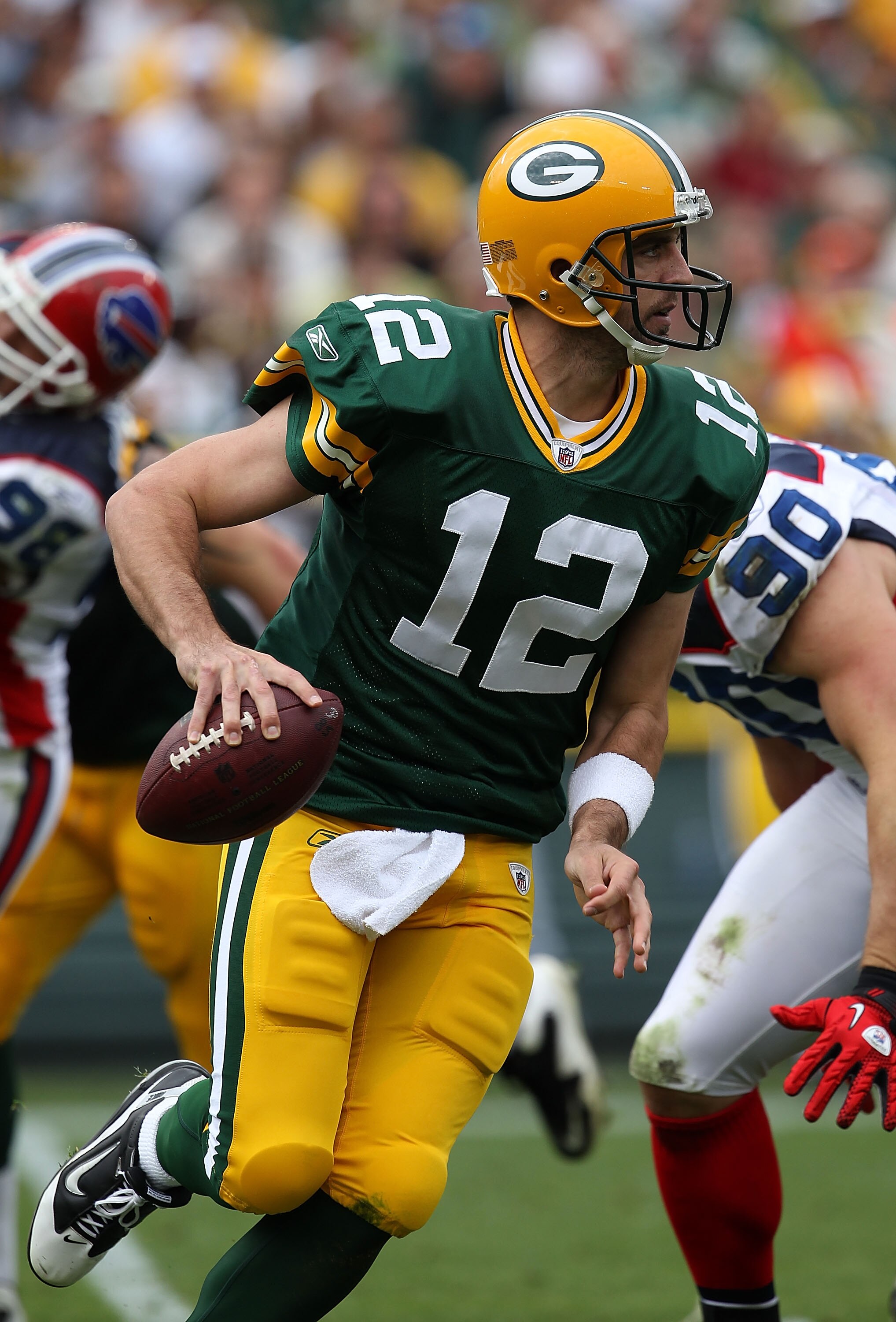 GREEN BAY, WI - SEPTEMBER 19: Aaron Rodgers #12 of the Green Bay Packers rolls out to look for a receiver against the Buffalo Bills at Lambeau Field on September 19, 2010 in Green Bay, Wisconsin. The Packers defeated the Bills 34-7. (Photo by Jonathan Dan GREEN BAY, WI - SEPTEMBER 19: Aaron Rodgers #12 of the Green Bay Packers rolls out to look for a receiver against the Buffalo Bills at Lambeau Field on September 19, 2010 in Green Bay, Wisconsin. The Packers defeated the Bills 34-7. (Photo by Jonathan Dan