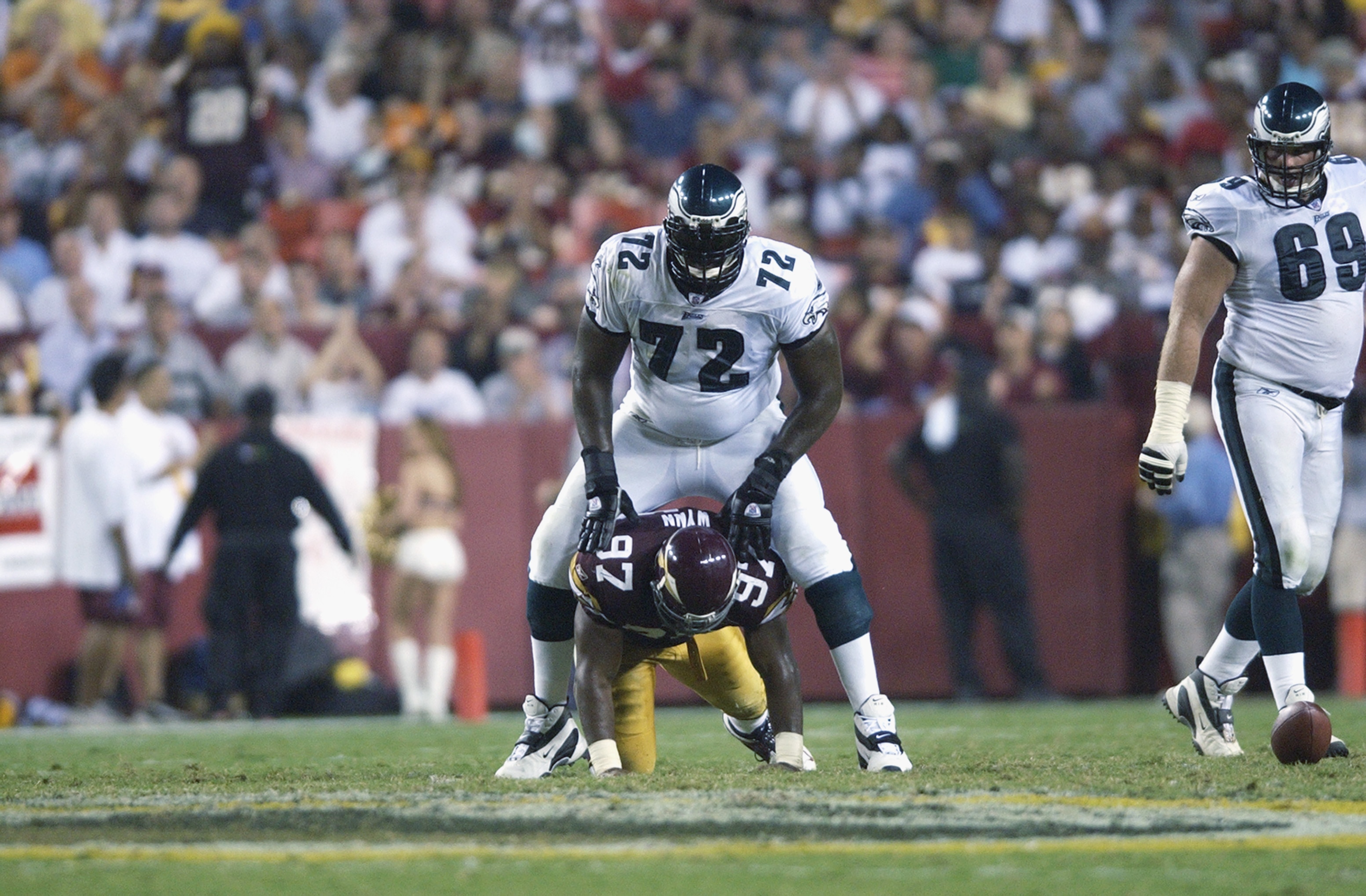LANDOVER, MD - SEPTEMBER 16:  Tra Thomas #72 of the Philadelphia Eagles steps over Renaldo Wynn #97 of the Washington Redskins after a play on September 16, 2002 at FedEx Field in Landover, Maryland.  The Eagles defeated the Redskins 37-7.  (Photo by Ezra