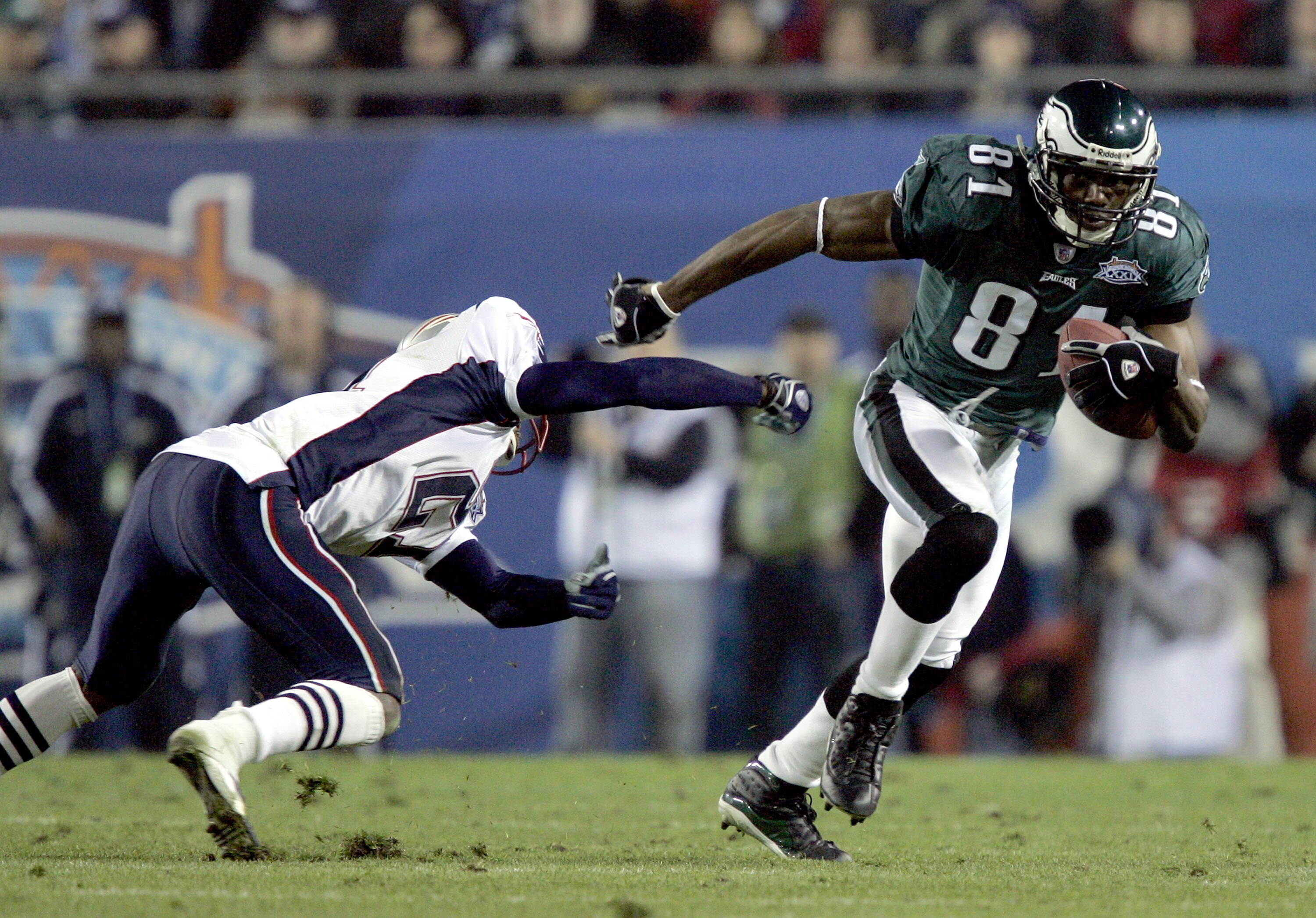 JACKSONVILLE, FL - FEBRUARY 6:  Wide receiver Terrell Owens #81 of the Philadelphia Eagles runs with the ball past Randall Gay #21 of the New England Patriots during the fourth quarter of Super Bowl XXXIX at Alltel Stadium on February 6, 2005 in Jacksonvi