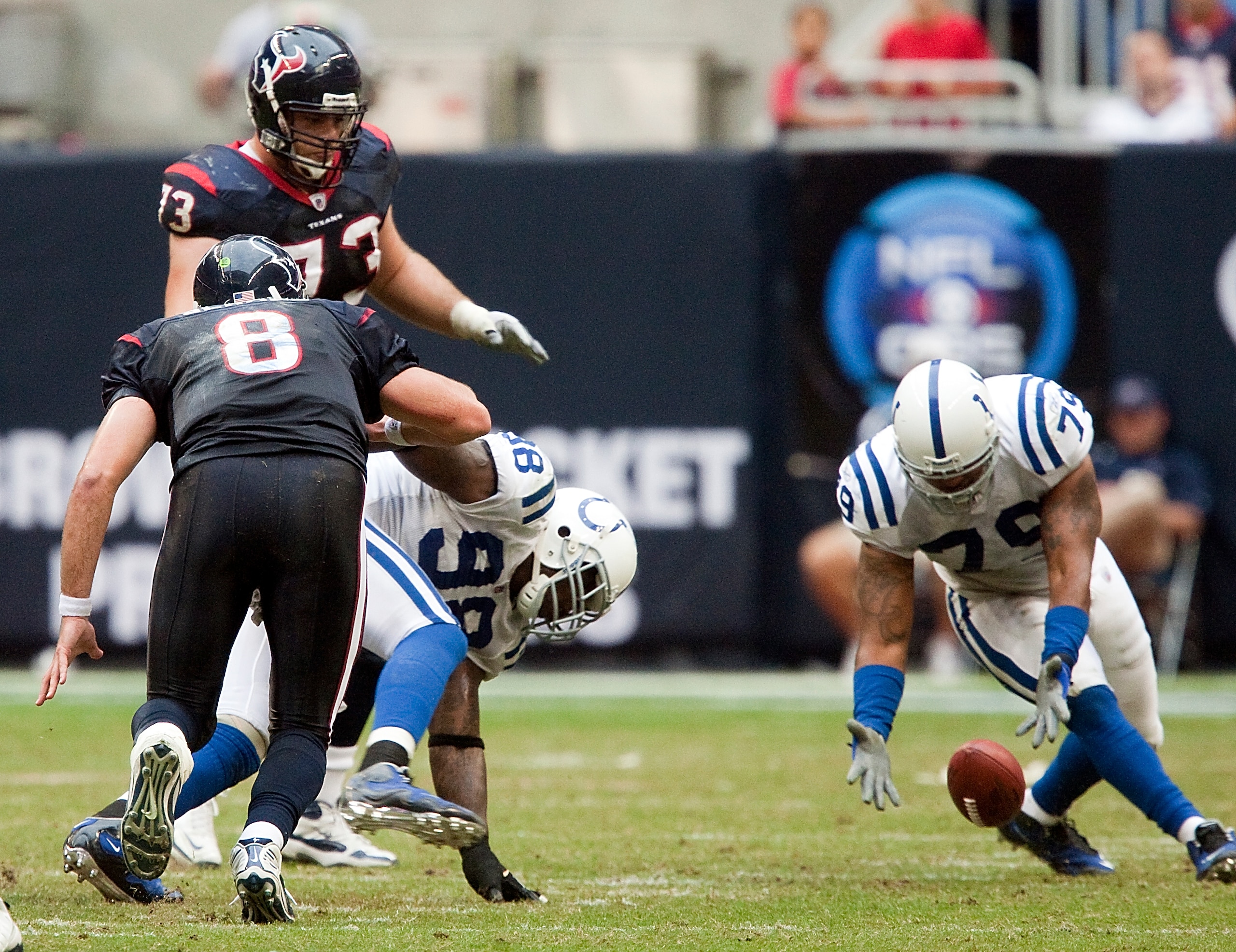 HOUSTON - NOVEMBER 29:  Defensive end Raheem Brock #79 of the Indianapolis Colts picks up a fumble caused by Robert Mathis #98 on Matt Schaub #8 of the Houston Texans at Reliant Stadium on November 29, 2009 in Houston, Texas.  (Photo by Bob Levey/Getty Im