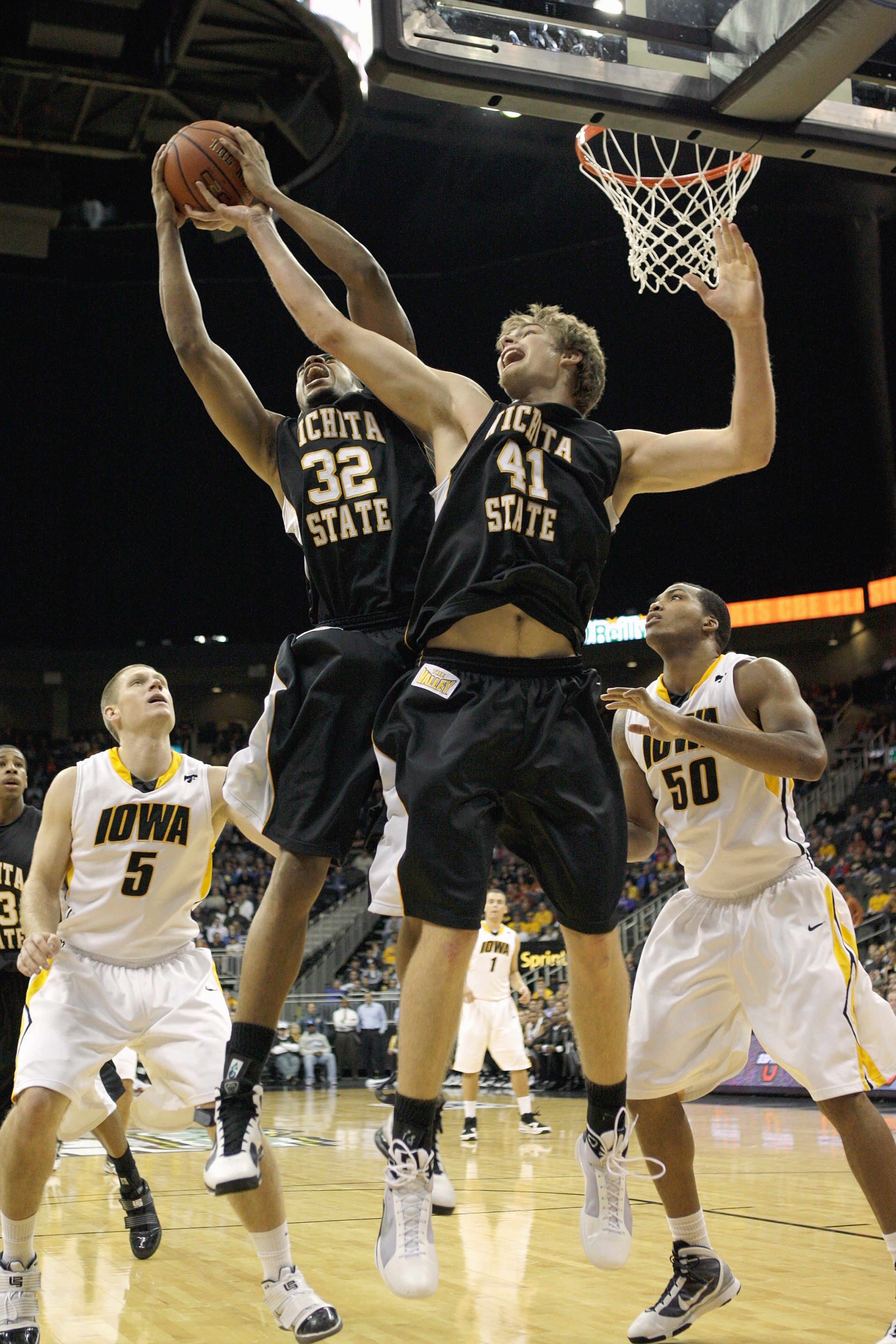 KANSAS CITY, MO - NOVEMBER 24: Gabe Blair #32 and Garrett Stutz #41 of the Wichita State Shockers rebounds the ball against Matt Gatens #5 and  Jarryd Cole #50 of the Iowa Hawkeyes during the CBE Classic consolation game on November 24, 2009 at Sprint Cen