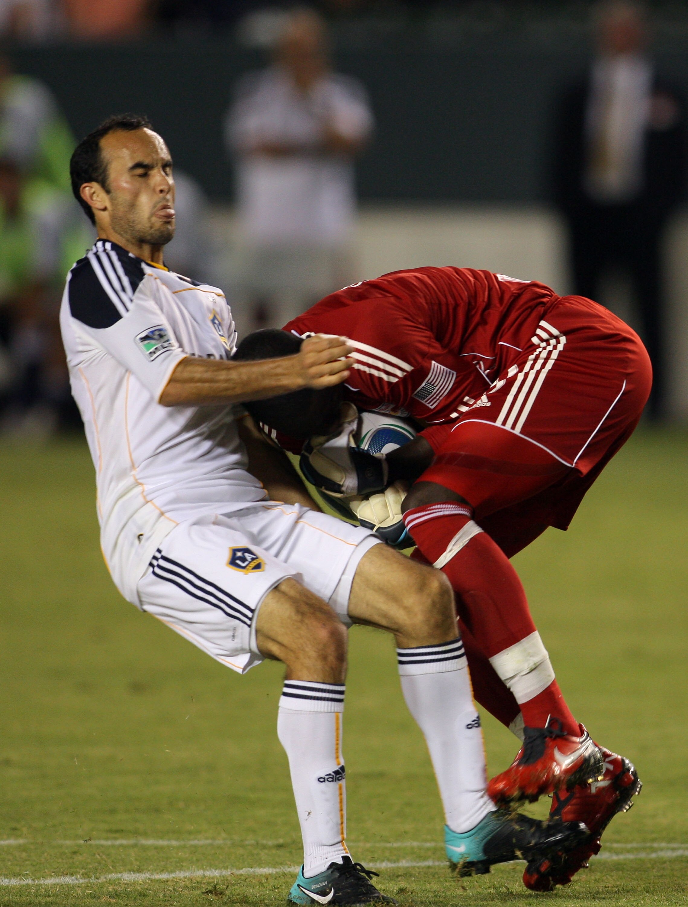 CARSON, CA - SEPTEMBER 24:  Landon Donovan #10 of the Los Angeles Galaxy collides with goalkeeper Bouna Coundoul #18 of New York Red Bulls in the first half during the MLS match at The Home Depot Center on September 24, 2010 in Carson, California. The Red