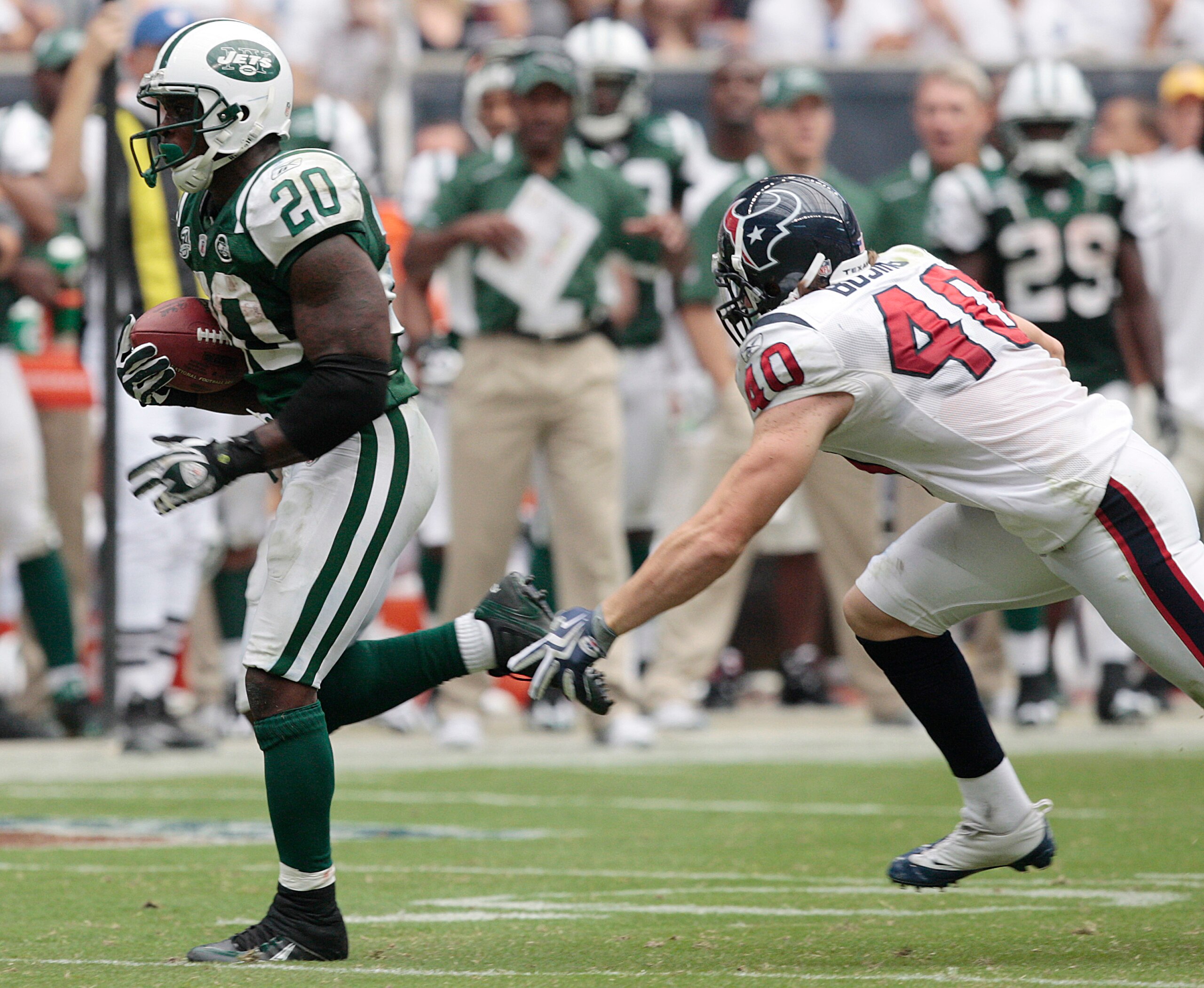 HOUSTON - SEPTEMBER 13:  Running back Thomas Jones #20 of the New York Jets eludes free safety John Busing #40 of the Houston Texans as he scores on a 38 yard run in the fourth quarter at Reliant Stadium on September 13, 2009 in Houston, Texas.  (Photo by
