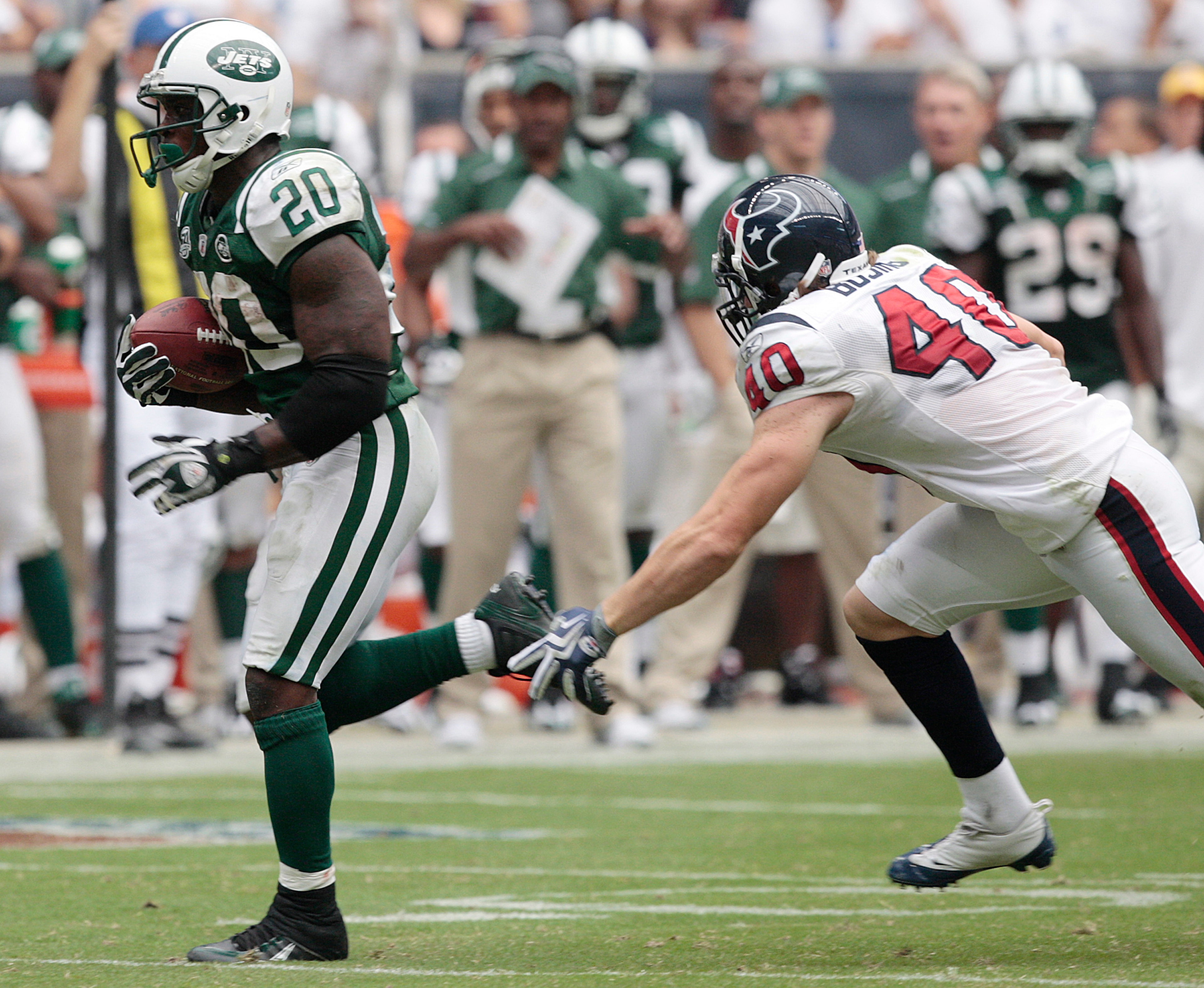 HOUSTON - SEPTEMBER 13:  Running back Thomas Jones #20 of the New York Jets eludes free safety John Busing #40 of the Houston Texans as he scores on a 38 yard run in the fourth quarter at Reliant Stadium on September 13, 2009 in Houston, Texas.  (Photo by