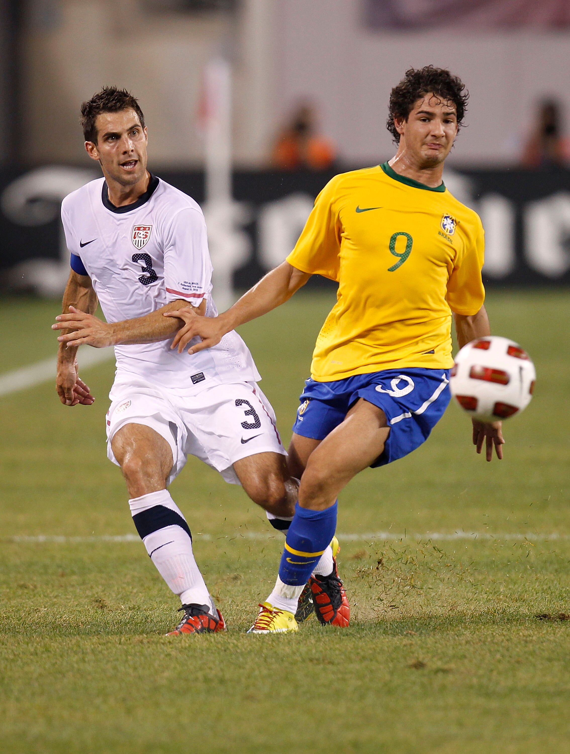 EAST RUTHERFORD, NJ - AUGUST 10:  Alexandre Paro #9 of Brazil and Carlos Bocanegra #3 of the U.S. fight for the ball in the first half of a friendly match at the New Meadowlands on August 10, 2010 in East Rutherford, New Jersey.  (Photo by Jeff Zelevansky