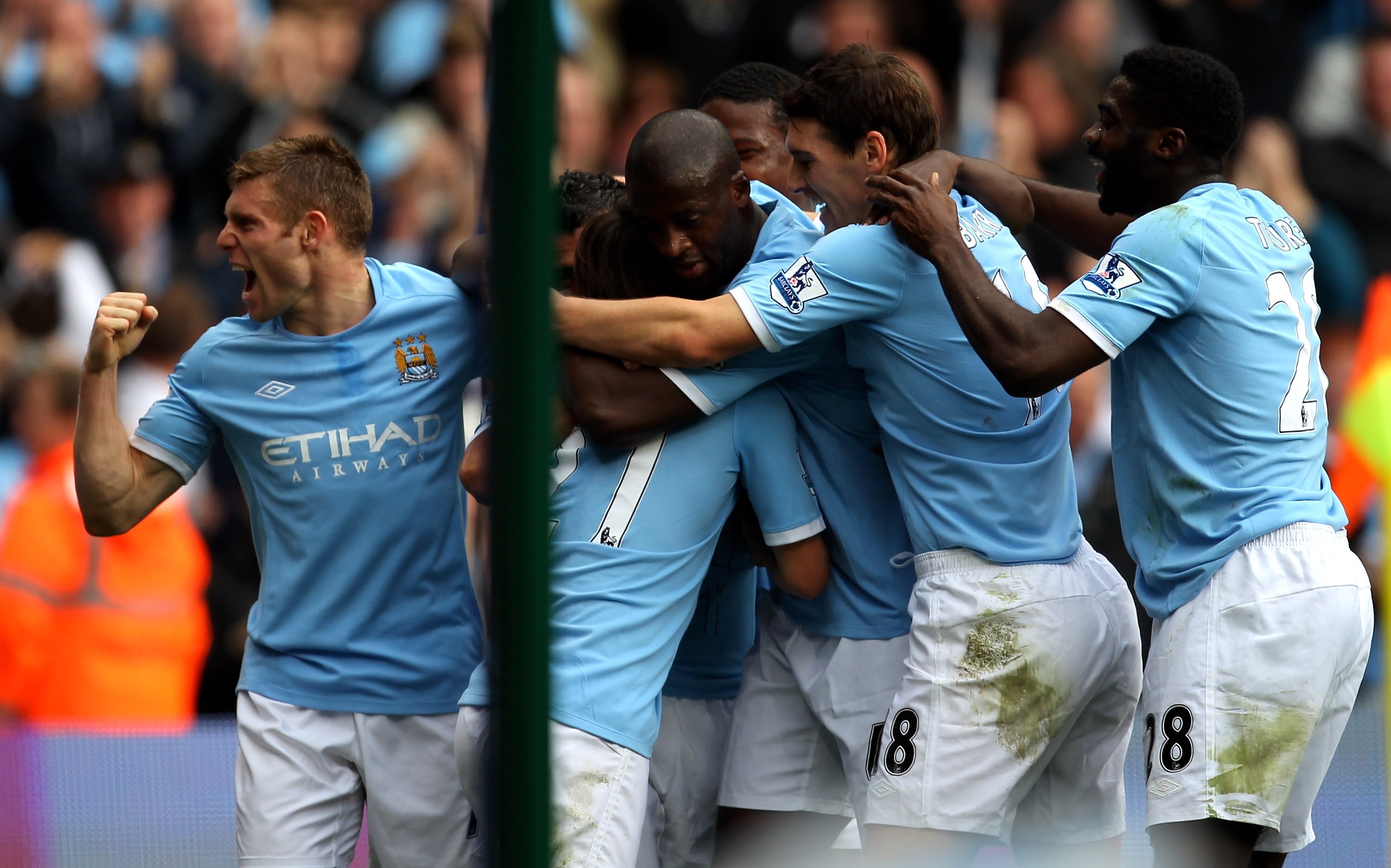 MANCHESTER, ENGLAND - SEPTEMBER 25:  Carlos Tevez of Manchester City is mobbed by his team mates after scoring the opening goal during the Barclays Premier League match between Manchester City and Chelsea at the City of Manchester Stadium on September 25,