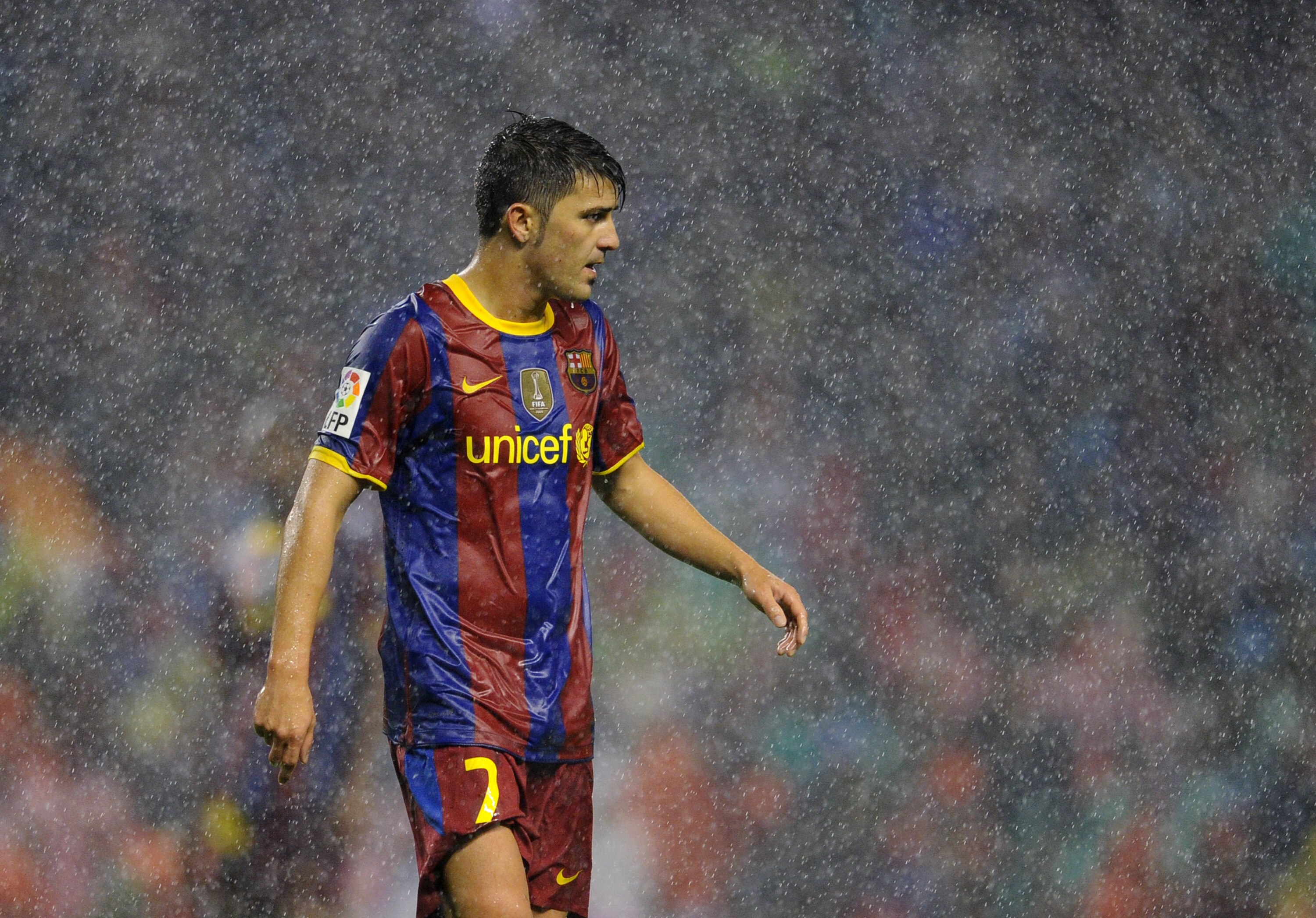 BILBAO, SPAIN - SEPTEMBER 25:  David Villa of Barcelona looks on in the pouring rain during the La Liga match between Athletic Bilbao and Barcelona at the San Mames Stadium on September 25, 2010 in Bilbao, Spain. Barcelona won the match 3-1.  (Photo by Ja