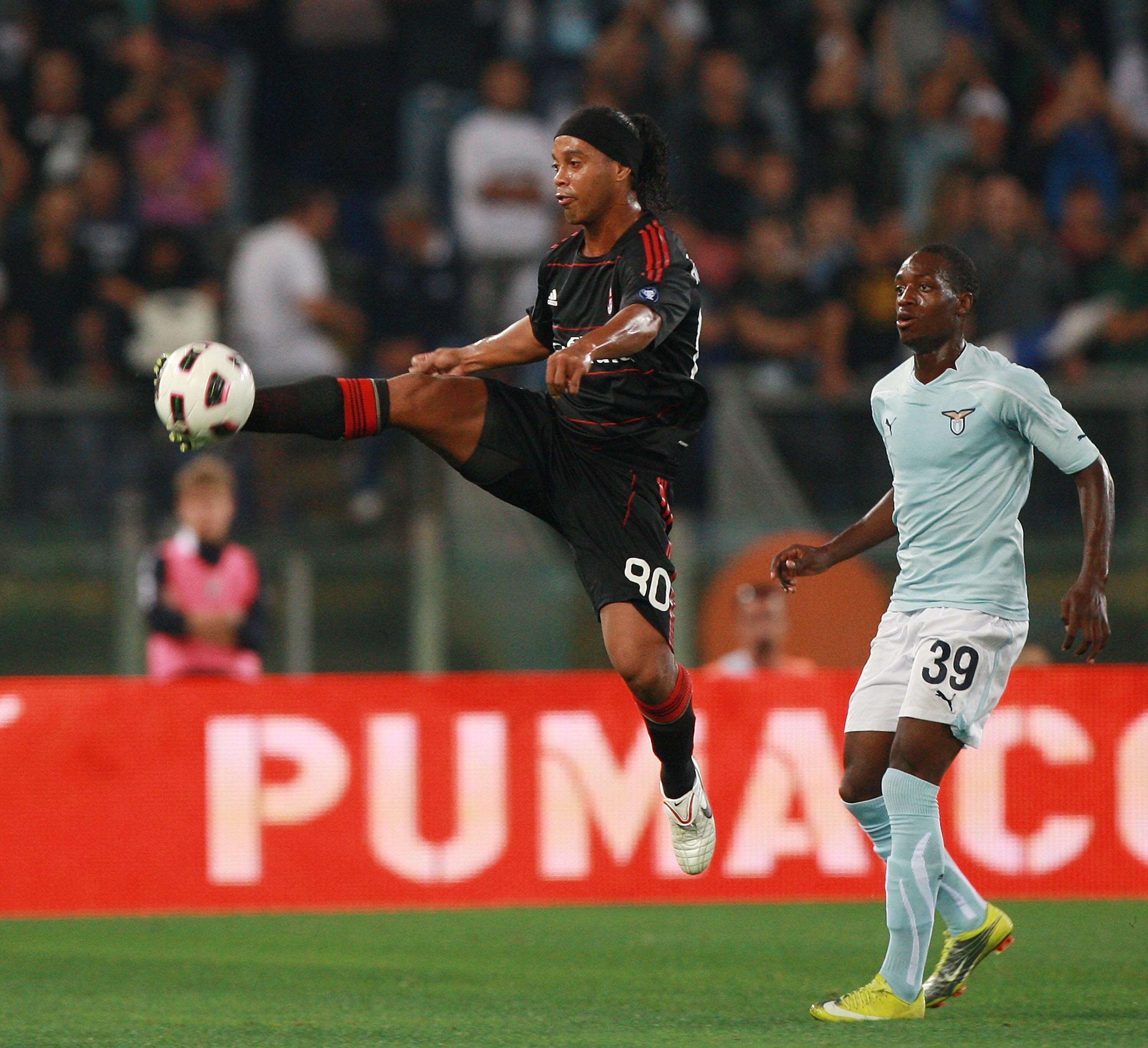 ROME - SEPTEMBER 22:  Ronaldihno (L) of AC Milan in action as Luis Cavanda looks on during the Serie A match between SS Lazio and AC Milan at Stadio Olimpico on September 22, 2010 in Rome, Italy.  (Photo by Paolo Bruno/Getty Images)