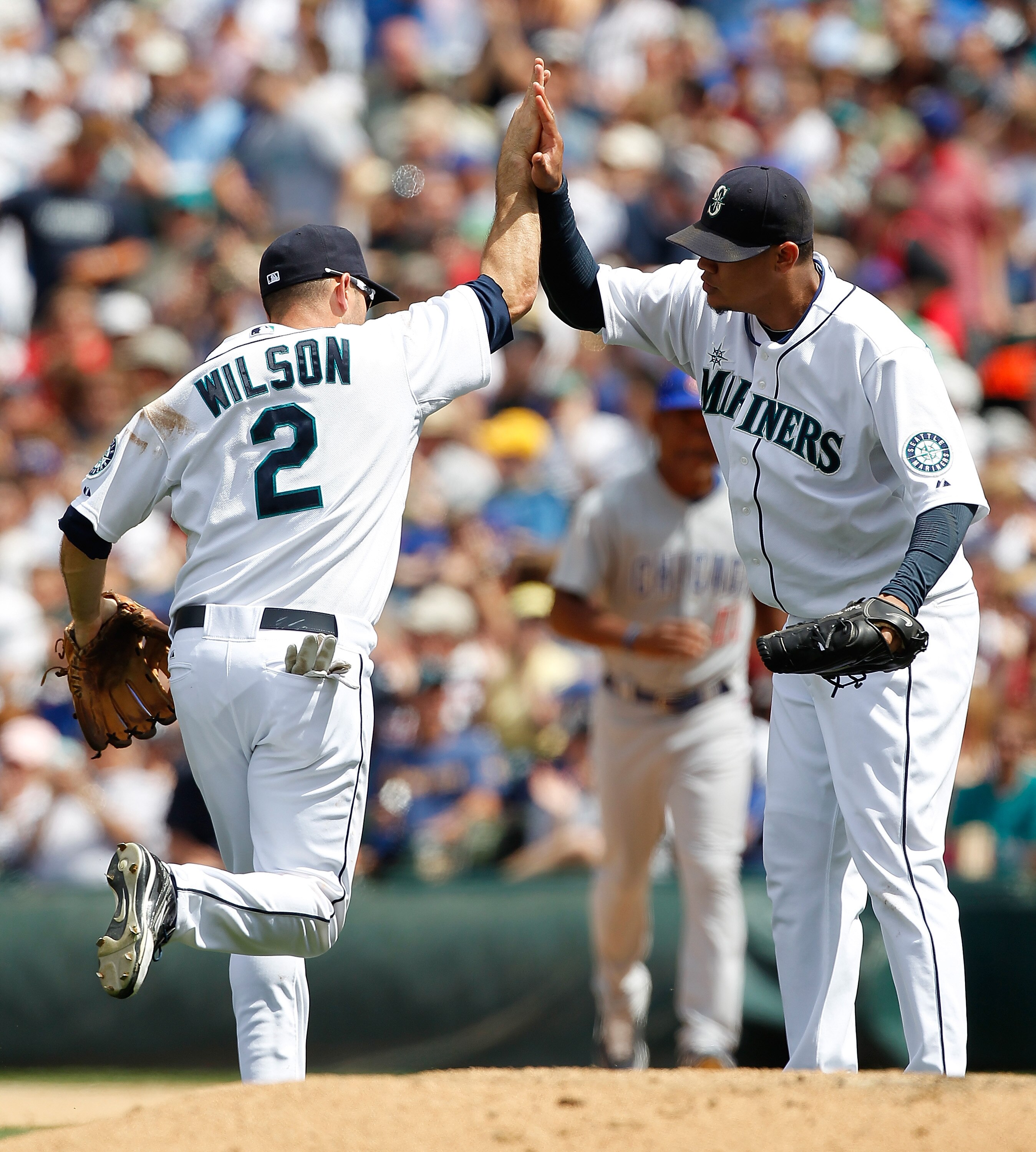 SEATTLE - JUNE 24:  Starting pitcher Felix Hernandez #34 of the Seattle Mariners congratulates shortstop Jack Wilson #2 after he threw out Marlon Byrd to end the eighth inning against the Chicago Cubs at Safeco Field on June 24, 2010 in Seattle, Washingto
