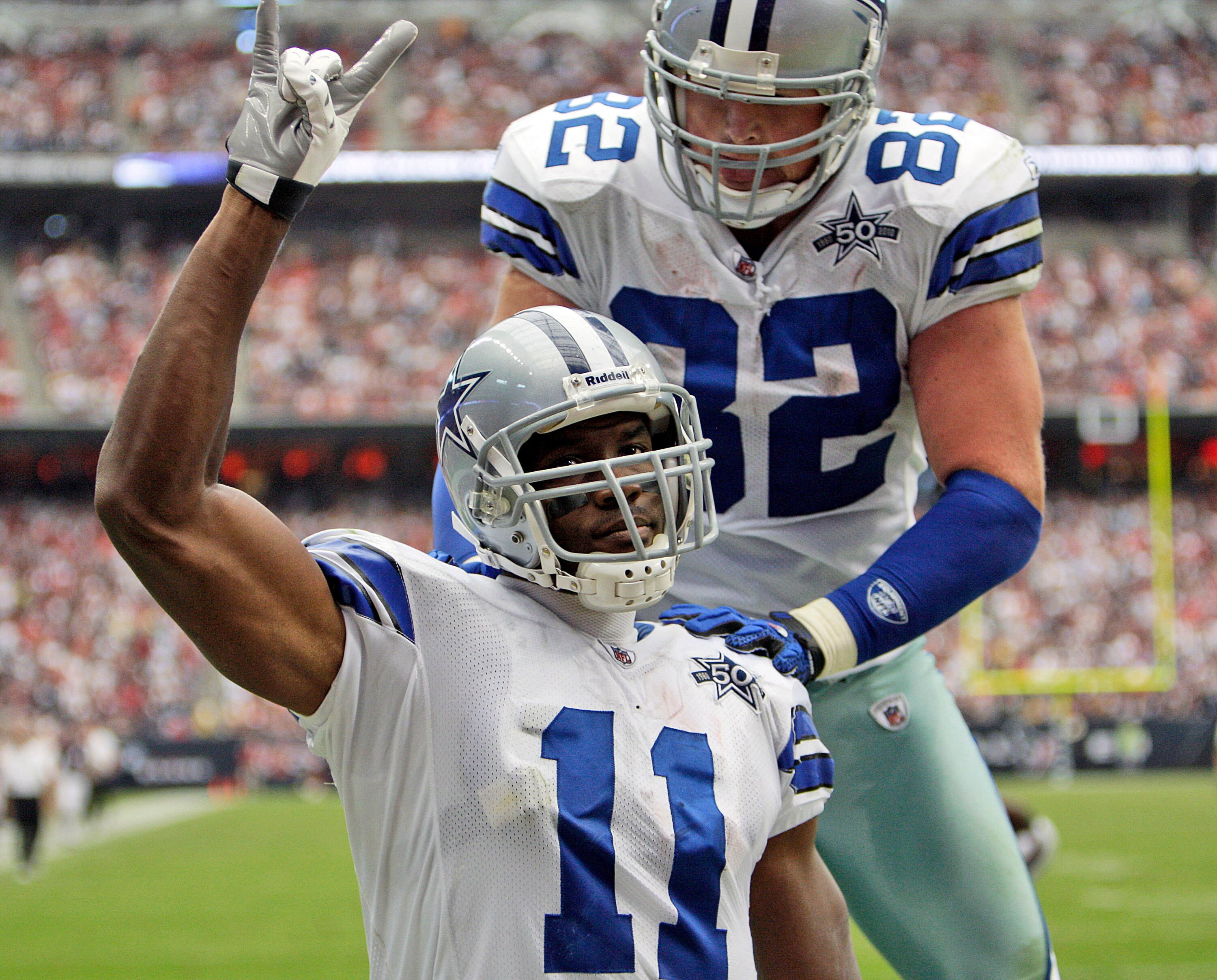 HOUSTON - SEPTEMBER 26:  Wide receiver Roy Williams #11 of the Dallas Cowboys celebrates with Jason Witten #82 after scoring against the Houston Texans at Reliant Stadium on September 26, 2010 in Houston, Texas.  (Photo by Bob Levey/Getty Images)
