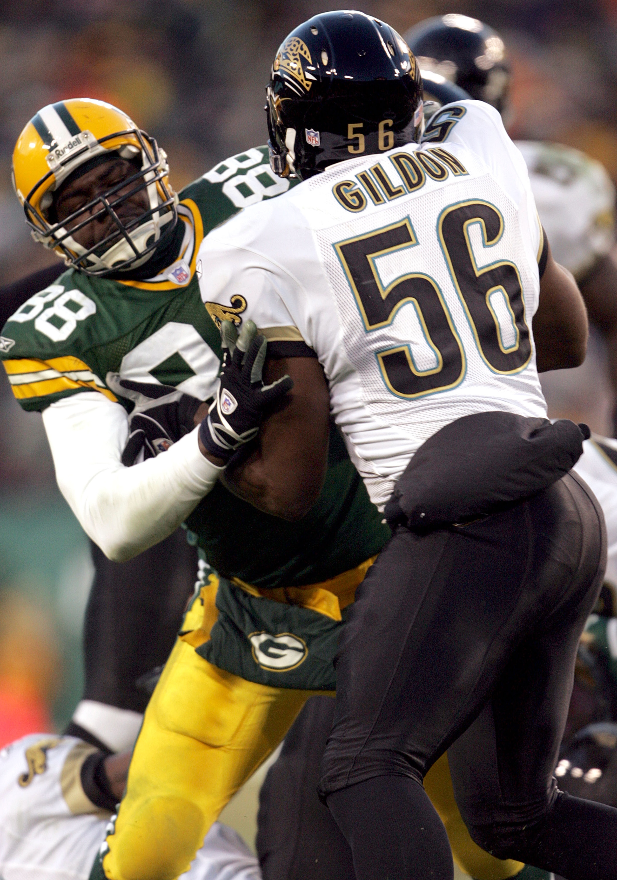GREEN BAY, WI - DECEMBER 19:  Bubba Franks #88 of the Green Bay Packers blocks Jason Gildon #56 of the Jacksonville Jaguars during the game at Lambeau Field on December 19, 2004 in Green Bay, Wisconsin. The Jaguars defeated the Packers 28-25.  (Photo by J