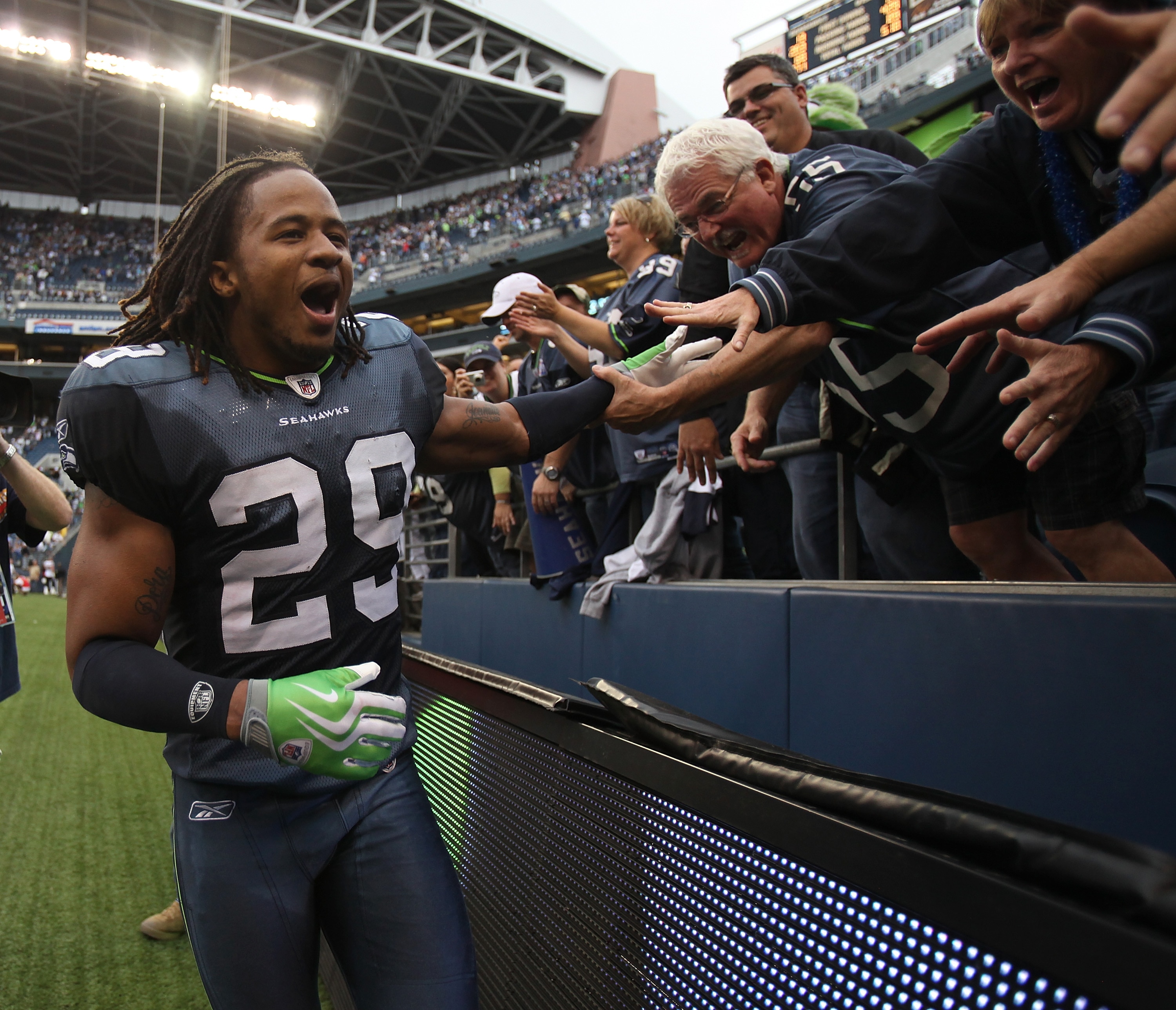 SEATTLE - SEPTEMBER 26:  Free safety Earl Thomas #29 of the Seattle Seahawks celebrates with fans after the Seahawks defeated the San Diego Chargers 27-20 at Qwest Field on September 26, 2010 in Seattle, Washington. (Photo by Otto Greule Jr/Getty Images)
