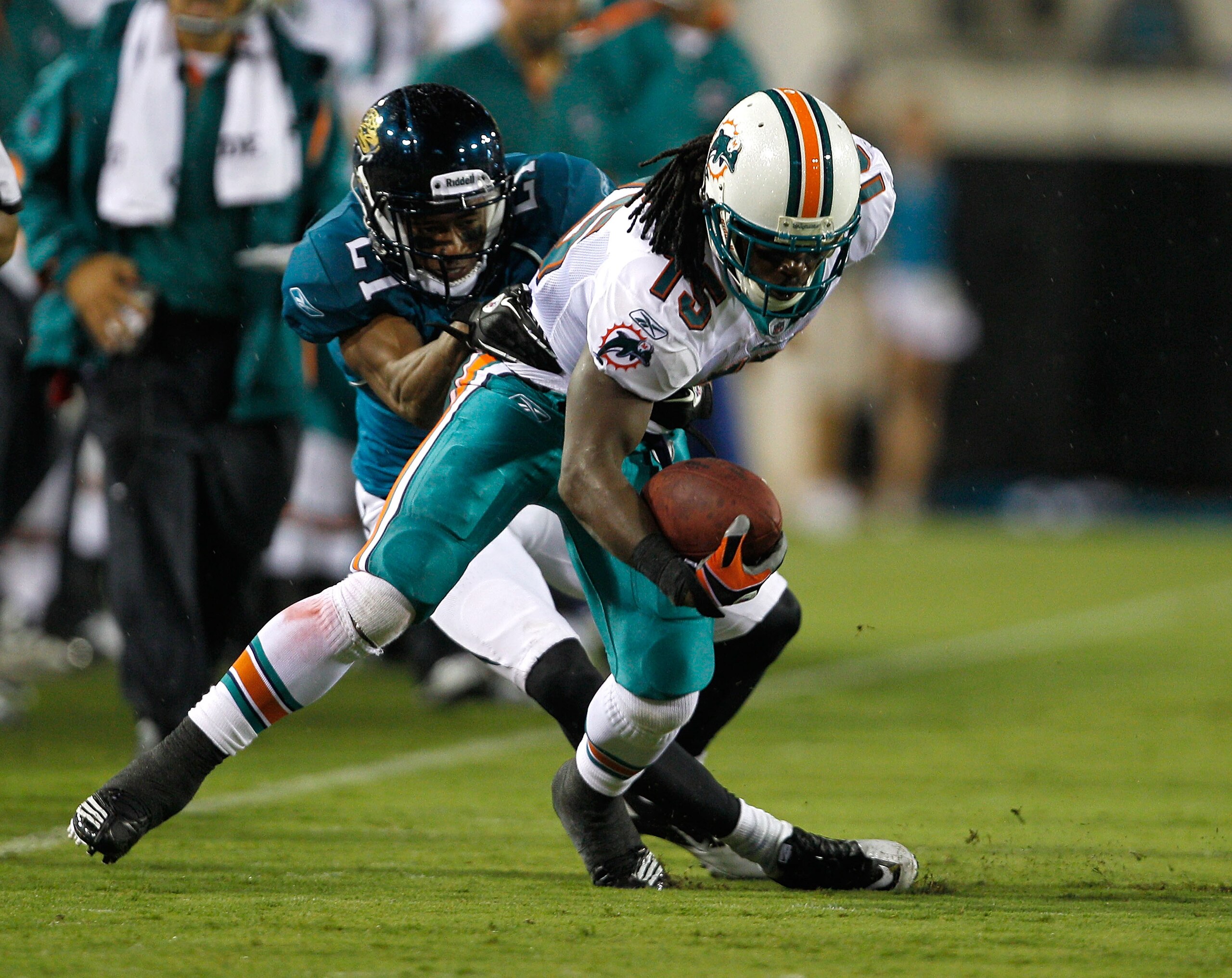 JACKSONVILLE, FL - AUGUST 21: Derek Cox #21 of the Jacksonville Jaguars tackles Devon Bess #15 of the Miami Dolphins during the preseason game at EverBank Field on August 21, 2010 in Jacksonville, Florida. (Photo by Sam Greenwood/Getty Images) JACKSONVILLE, FL - AUGUST 21: Derek Cox #21 of the Jacksonville Jaguars tackles Devon Bess #15 of the Miami Dolphins during the preseason game at EverBank Field on August 21, 2010 in Jacksonville, Florida. (Photo by Sam Greenwood/Getty Images)