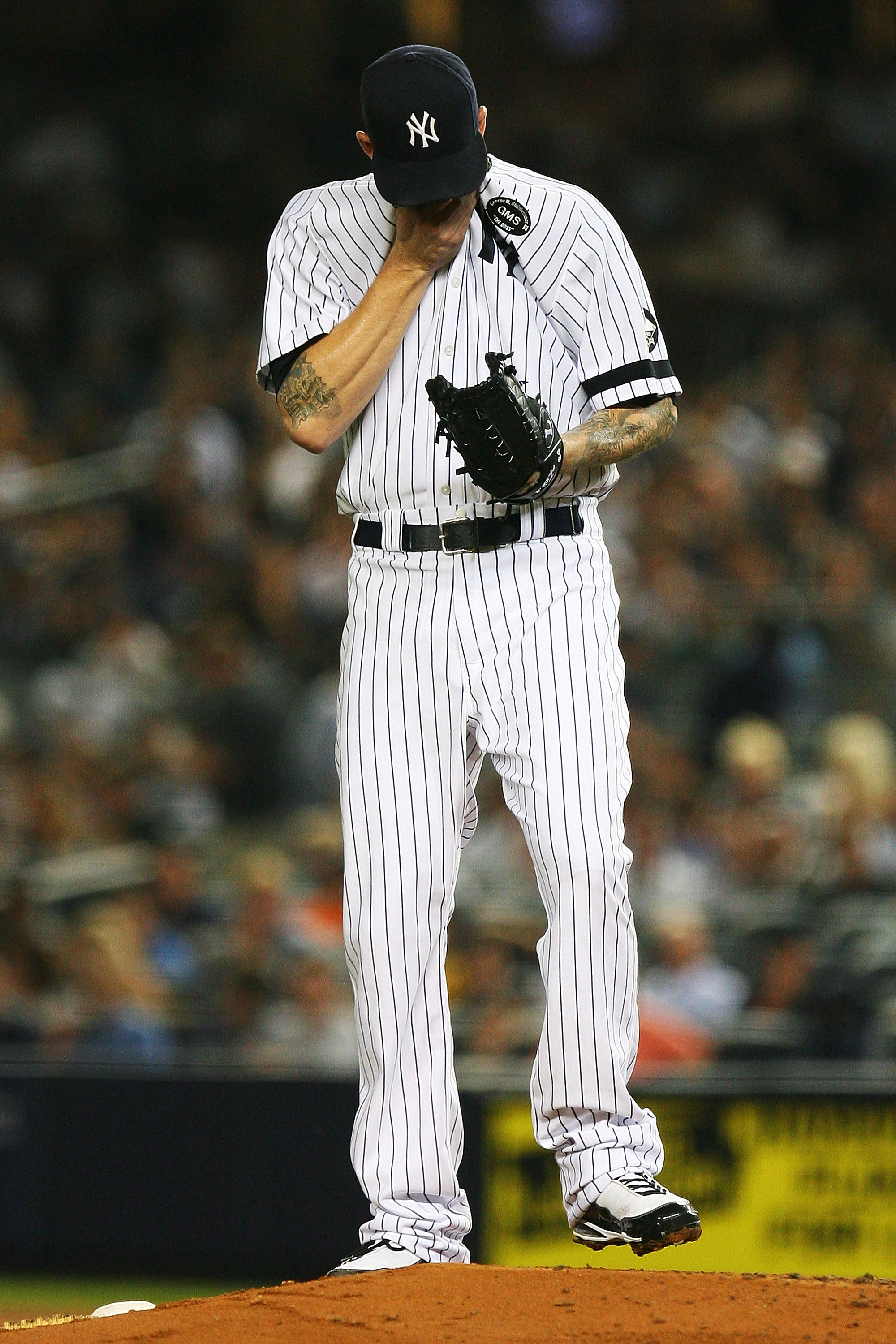NEW YORK - SEPTEMBER 22: A.J. Burnett #34 of the New York Yankees wipes his brow during a game against the Tampa Bay Rays on September 22, 2010 at Yankee Stadium in the Bronx borough of New York City. (Photo by Andrew Burton/Getty Images) NEW YORK - SEPTEMBER 22: A.J. Burnett #34 of the New York Yankees wipes his brow during a game against the Tampa Bay Rays on September 22, 2010 at Yankee Stadium in the Bronx borough of New York City. (Photo by Andrew Burton/Getty Images)