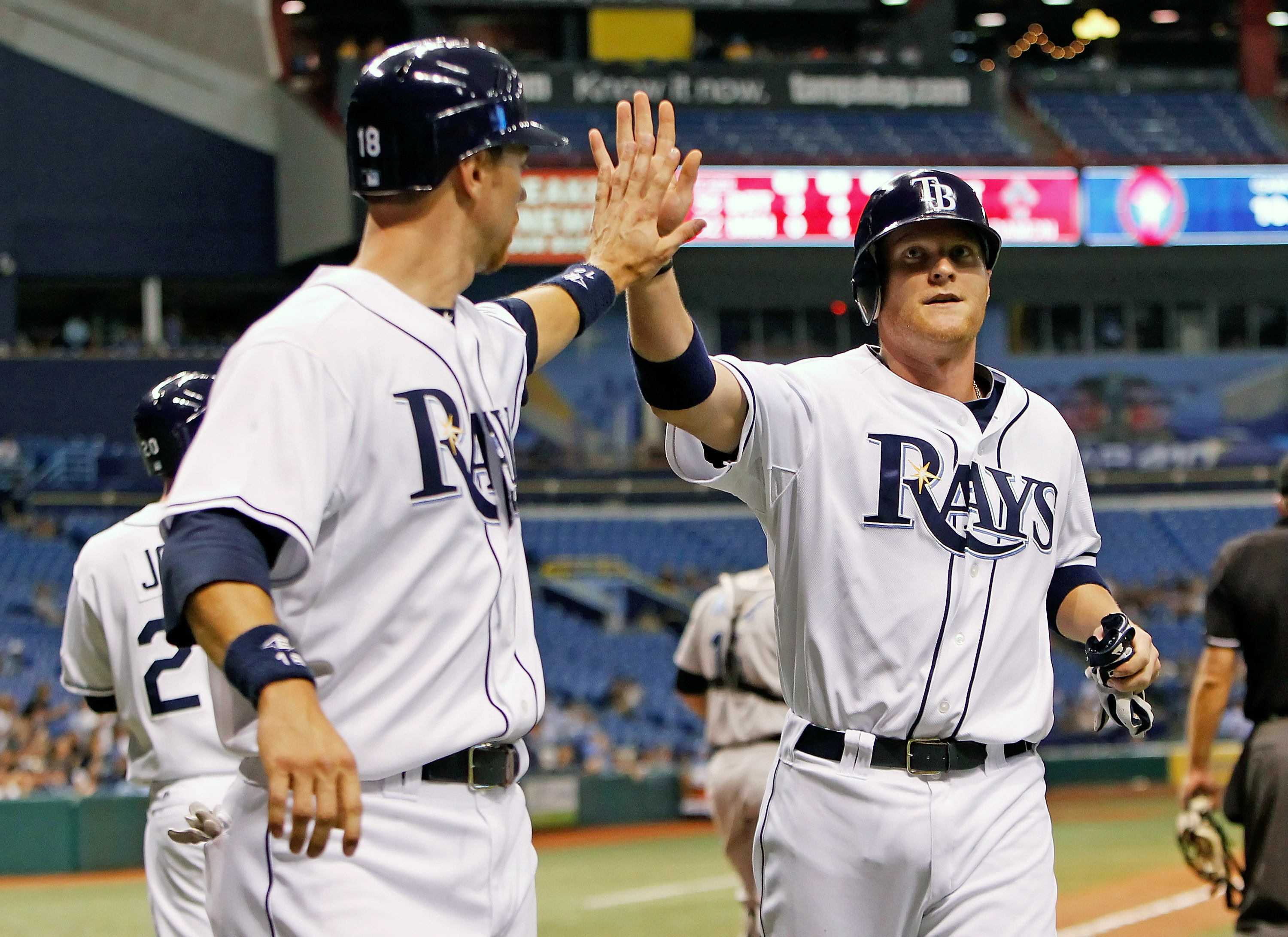 ST. PETERSBURG - AUGUST 31:  Designated hitter Dan Johnson #24 (right) of the Tampa Bay Rays is congratulated by Ben Zobrist #18 after scoring a run against the Toronto Blue Jays during the game at Tropicana Field on August 31, 2010 in St. Petersburg, Flo