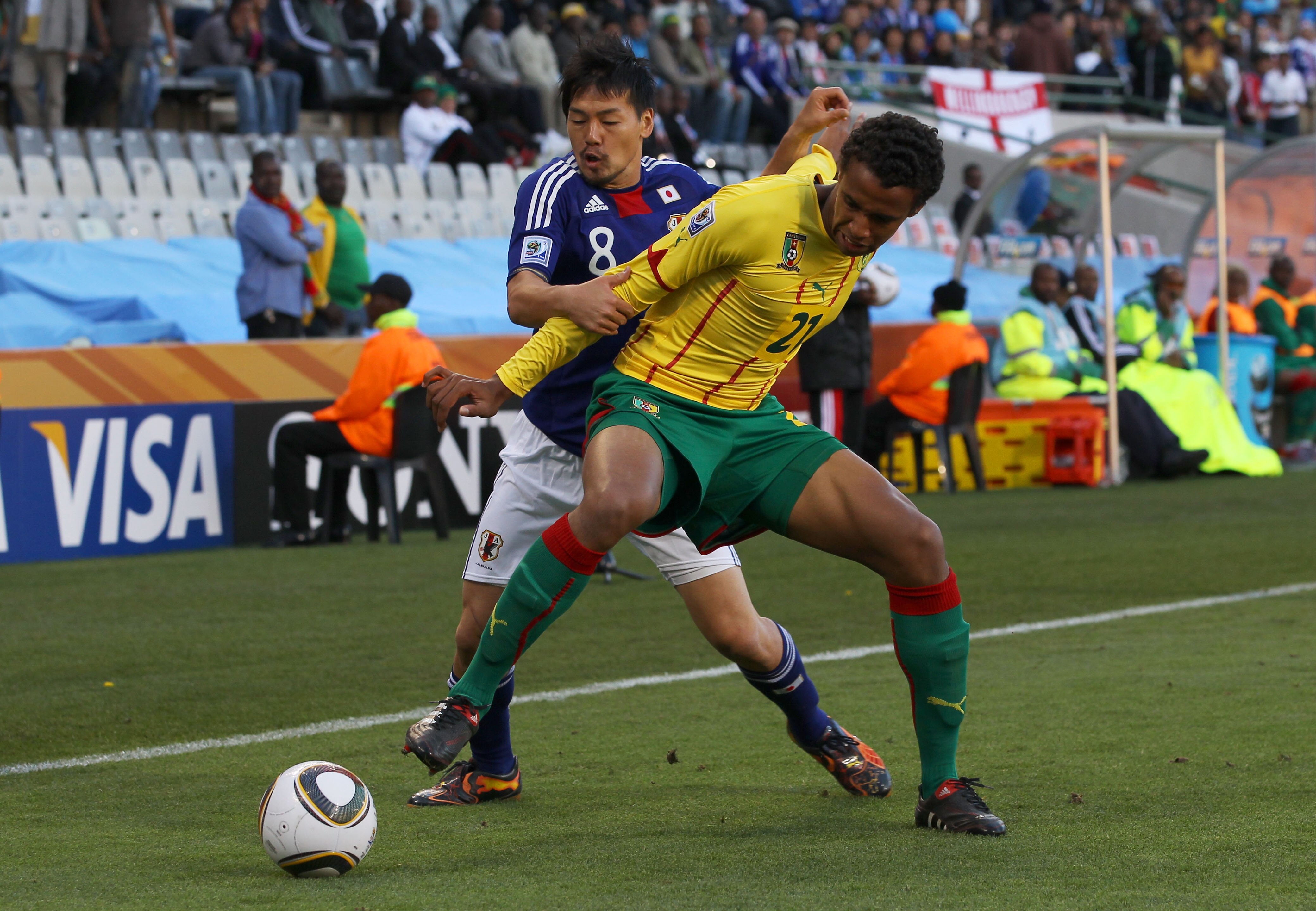BLOEMFONTEIN, SOUTH AFRICA - JUNE 14:  Daisuke Matsui of Japan and Joel Matip of Cameroon tussle for the ball during the 2010 FIFA World Cup South Africa Group E match between Japan and Cameroon at the Free State Stadium on June 14, 2010 in Mangaung/Bloem