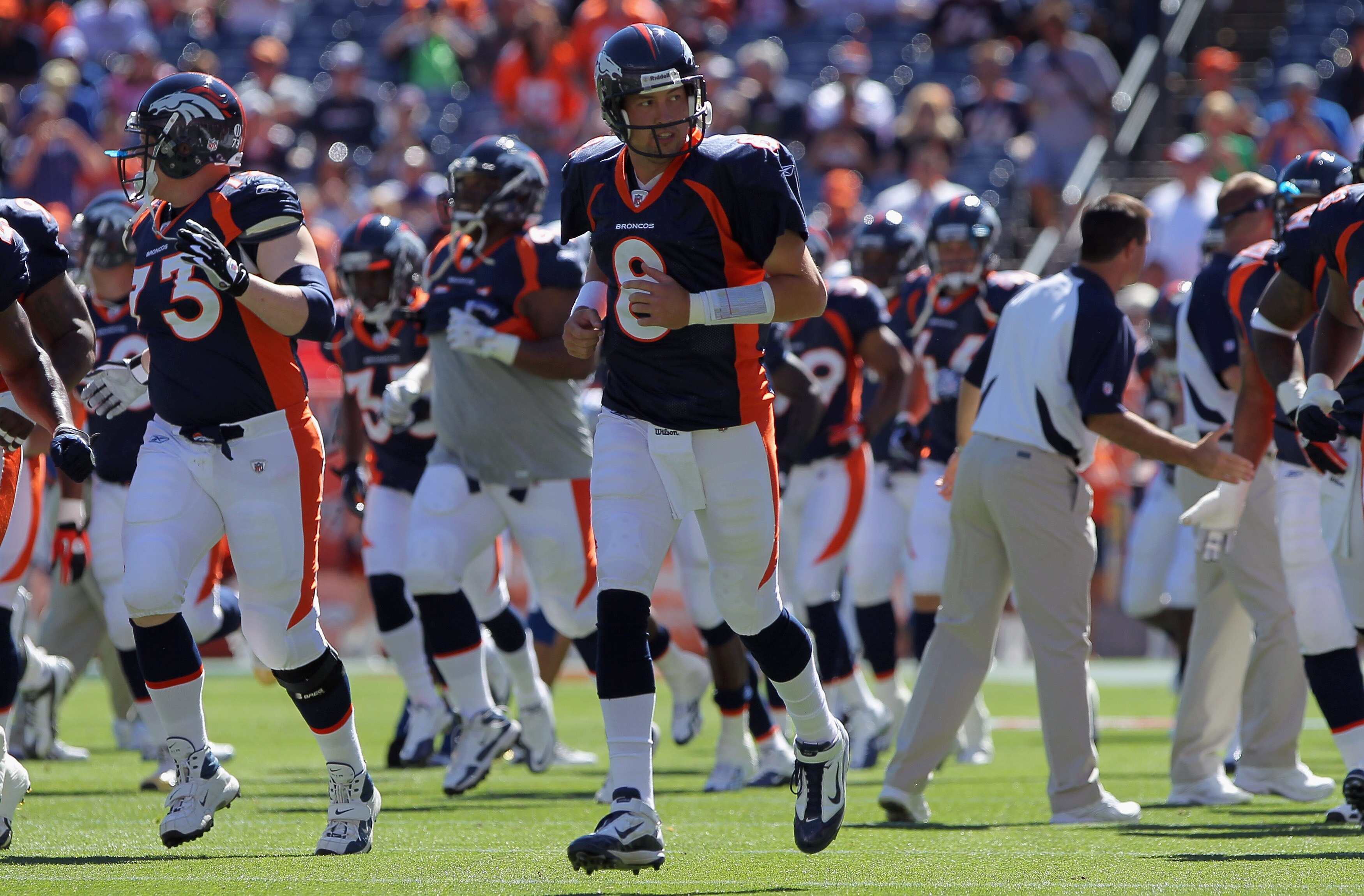 DENVER - SEPTEMBER 26:  Quarterback Kyle Orton #8 and the Denver Broncos take the field to face the Indianapolis Colts at INVESCO Field at Mile High on September 26, 2010 in Denver, Colorado.  (Photo by Doug Pensinger/Getty Images)