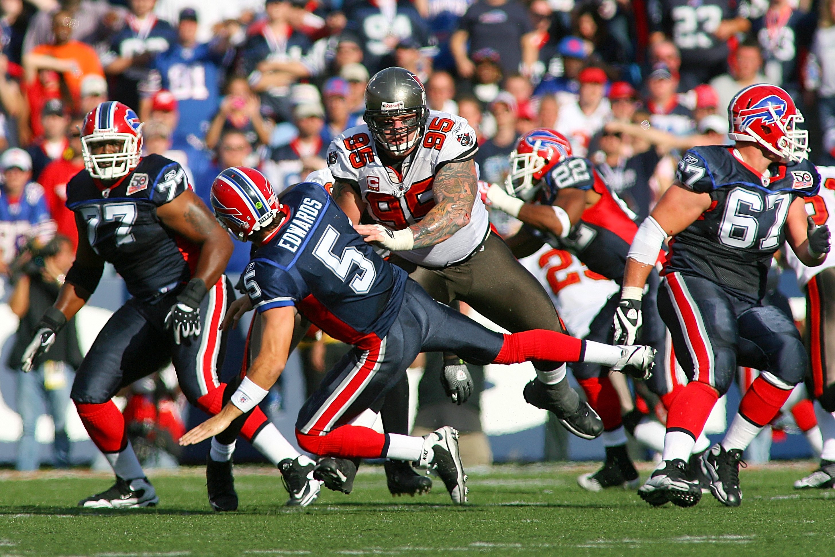 ORCHARD PARK, NY - SEPTEMBER 20:  Defensive tackle Chris Hovan #95 (C) of the Tampa Bay Buccaneers tackles quarterback Trent Edwards #5 of the Buffalo Bills during the game at Ralph Wilson Stadium on September 20, 2009 in Orchard Park, New York.  The Bill