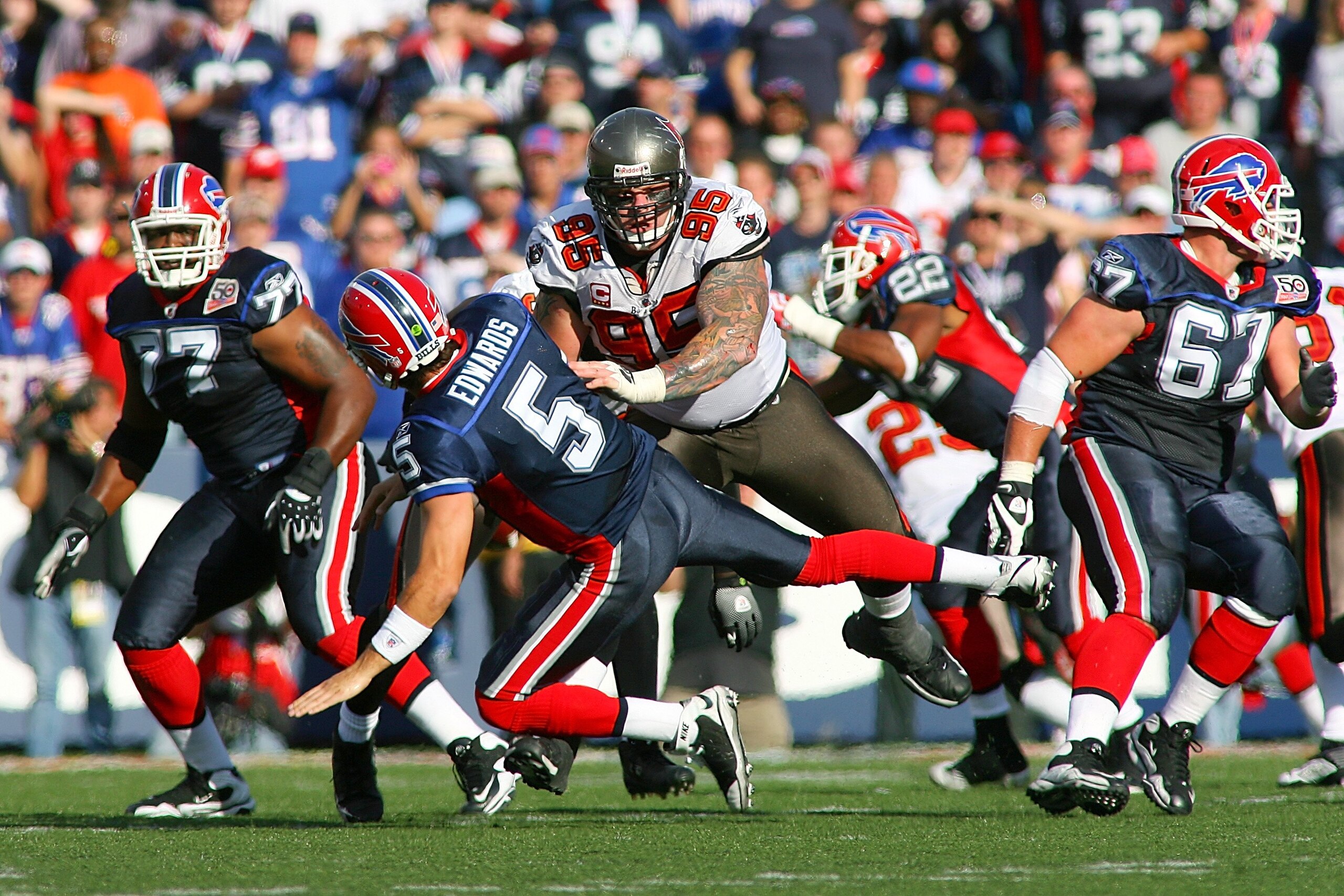 ORCHARD PARK, NY - SEPTEMBER 20:  Defensive tackle Chris Hovan #95 (C) of the Tampa Bay Buccaneers tackles quarterback Trent Edwards #5 of the Buffalo Bills during the game at Ralph Wilson Stadium on September 20, 2009 in Orchard Park, New York.  The Bill