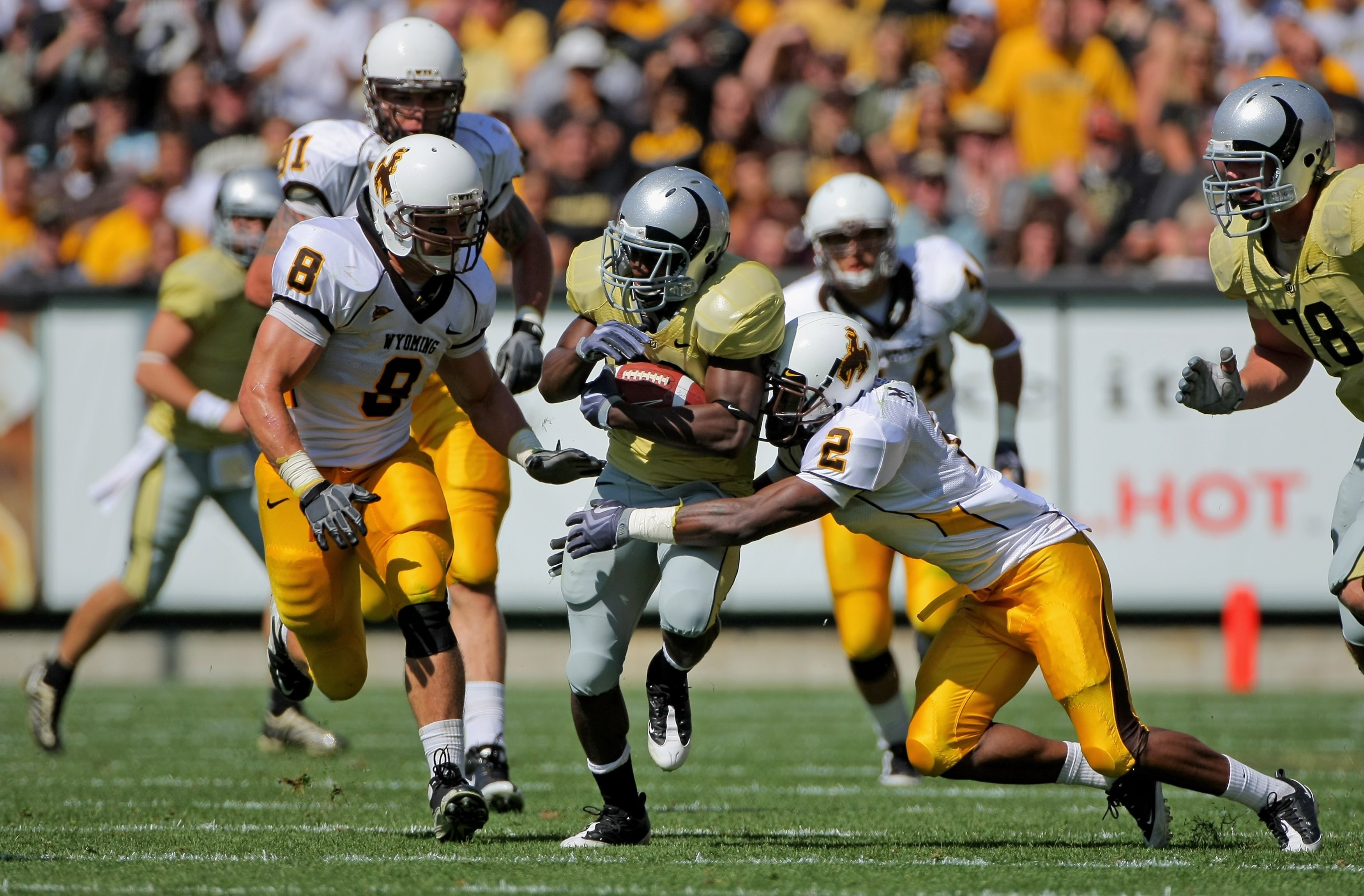 BOULDER, CO - SEPTEMBER 19:  Running back Brian Lockridge #20 of the Colorado Buffaloes is tackled by Marcell Gipson #2 of the Wyoming Cowboys at Folsom Field on September 19, 2009 in Boulder, Colorado. The Buffaloes defeated the Cowboys 24-0.  (Photo by