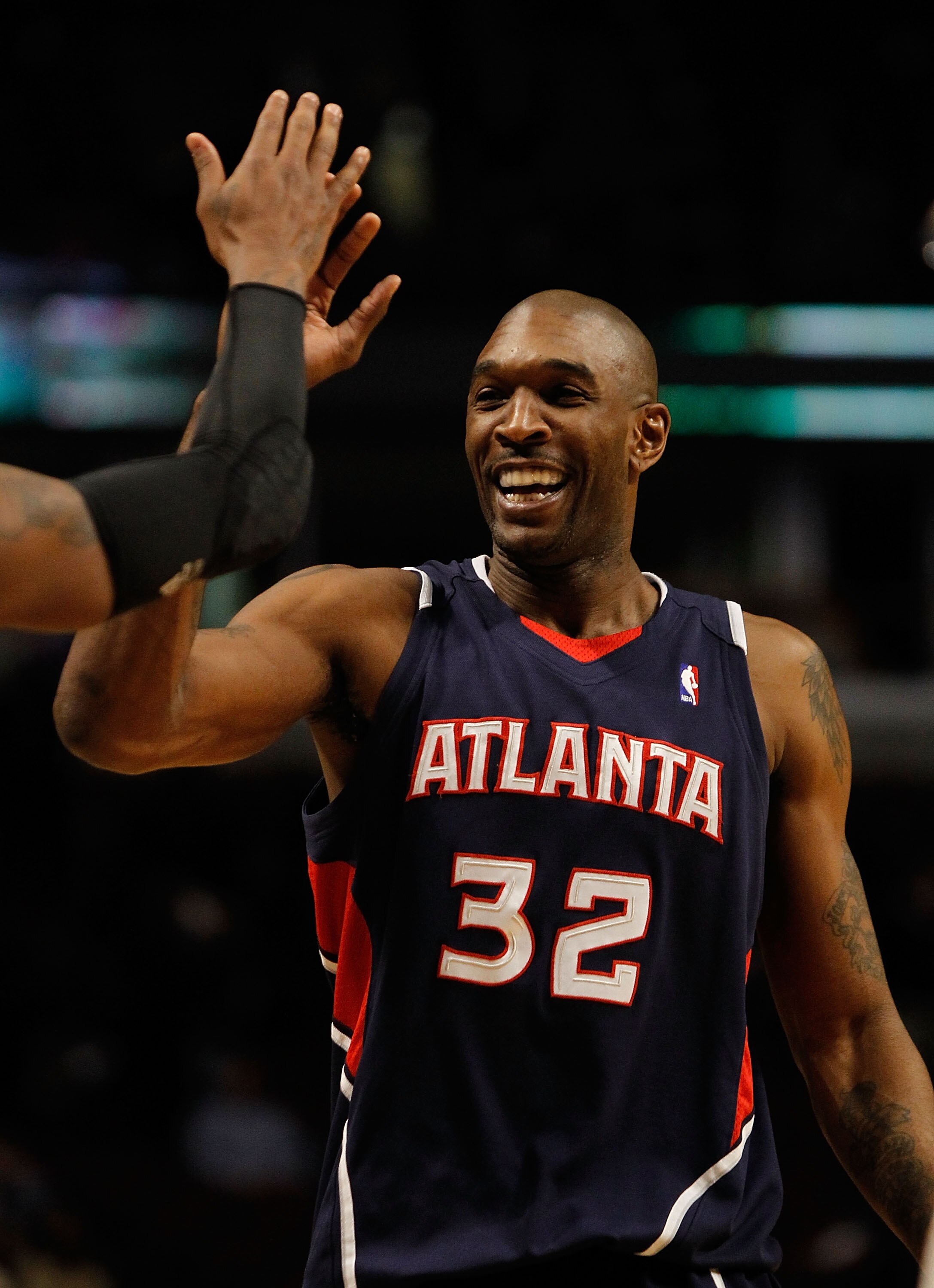 CHICAGO - MARCH 01: Joe Smith #32 of the Atlanta Hawks is congratulated by teammates after a win over the Chicago Bulls at the United Center on March 1, 2010 in Chicago, Illinois. The Hawks defeated the Bulls 116-92. NOTE TO USER: User expressly acknowled CHICAGO - MARCH 01: Joe Smith #32 of the Atlanta Hawks is congratulated by teammates after a win over the Chicago Bulls at the United Center on March 1, 2010 in Chicago, Illinois. The Hawks defeated the Bulls 116-92. NOTE TO USER: User expressly acknowled