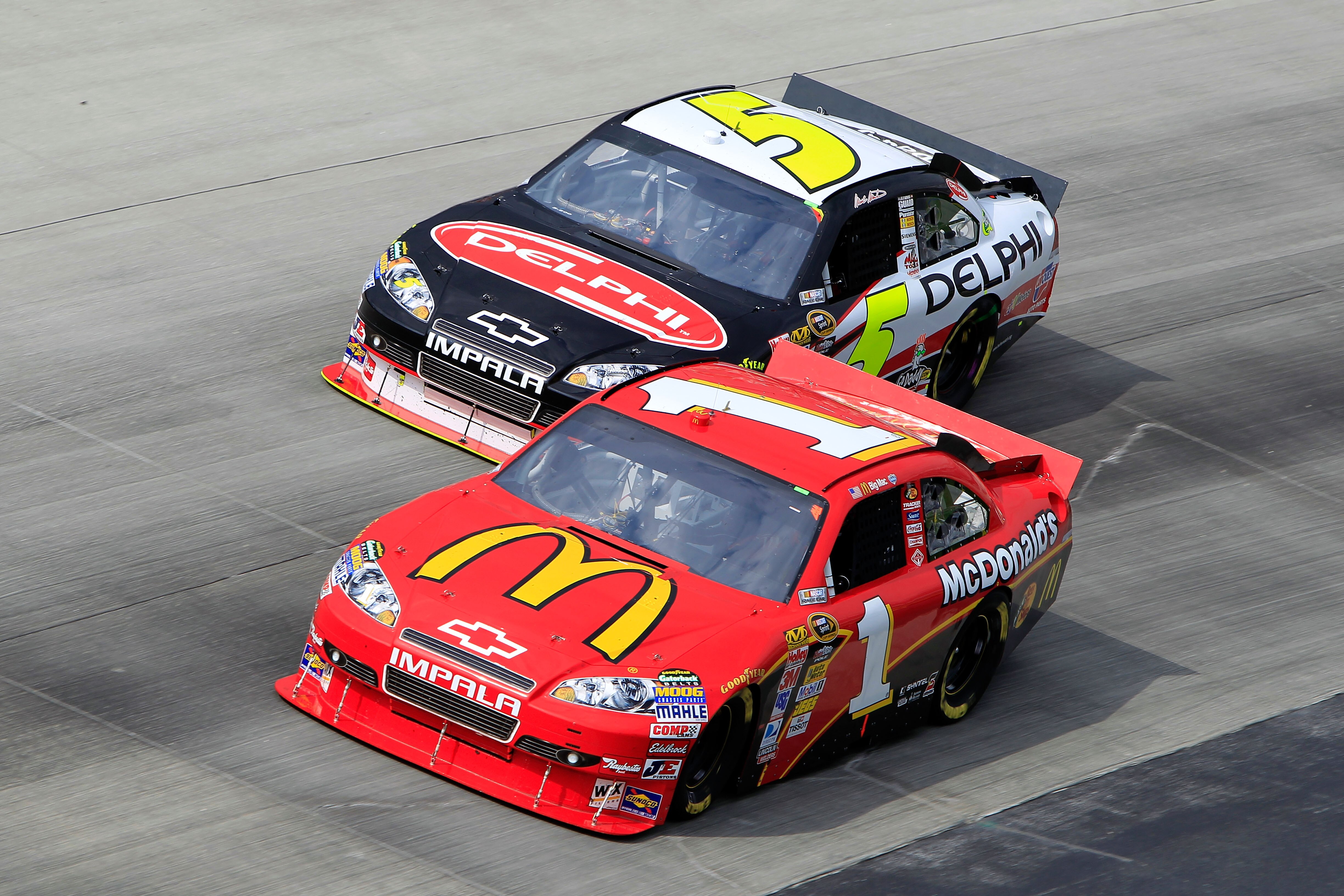 DOVER, DE - SEPTEMBER 26:  Jamie McMurray, driver of the #1 McDonalds's Chevrolet, races Mark Martin, driver of the #5 Delphi/GoDaddy.com Chevrolet, during the NASCAR Sprint Cup Series AAA 400 at Dover International Speedway on September 26, 2010 in Dover