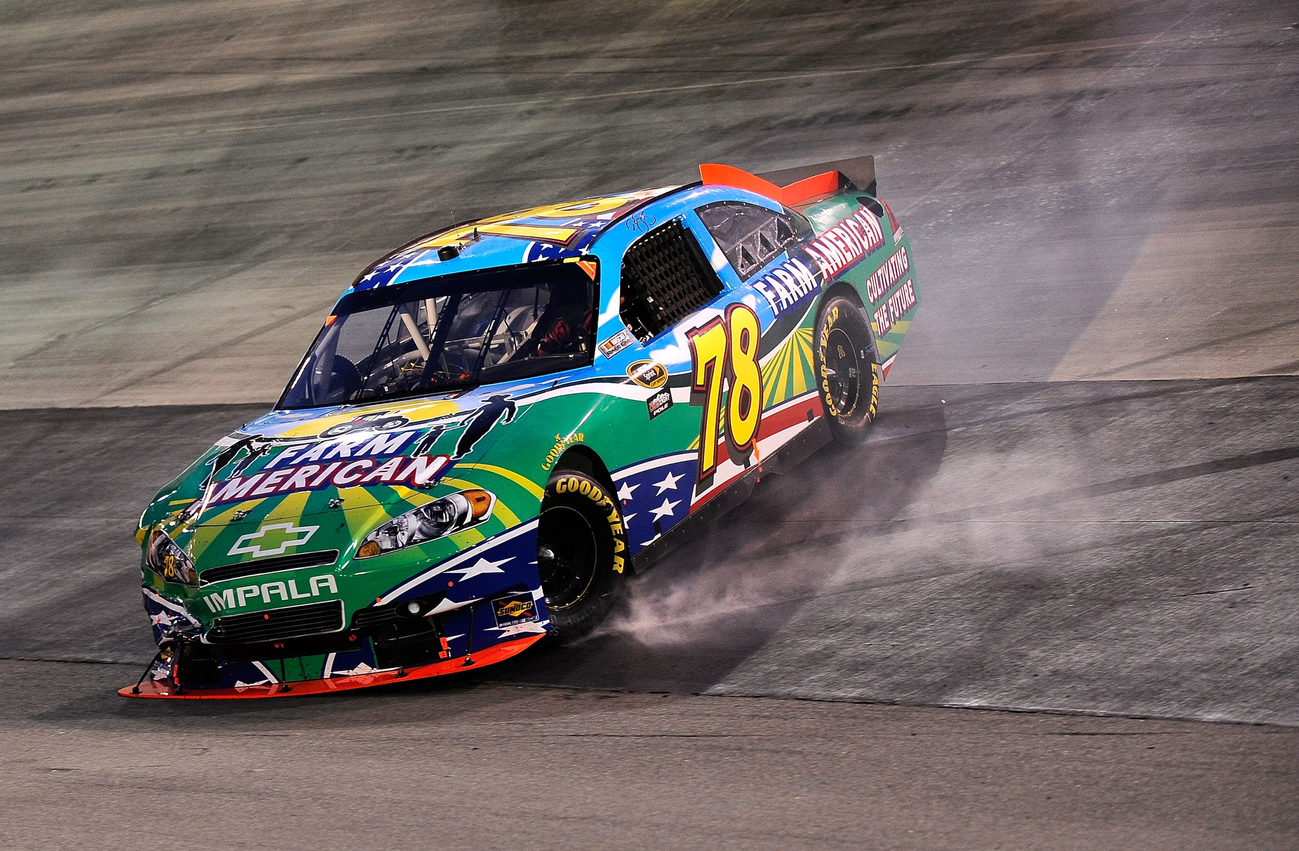 BRISTOL, TN - AUGUST 21:  Regan Smith, driver of the #78 Farm American.com Chevrolet, spins out during the NASCAR Sprint Cup Series IRWIN Tools Night Race at Bristol Motor Speedway on August 21, 2010 in Bristol, Tennessee.  (Photo by Rusty Jarrett/Getty I