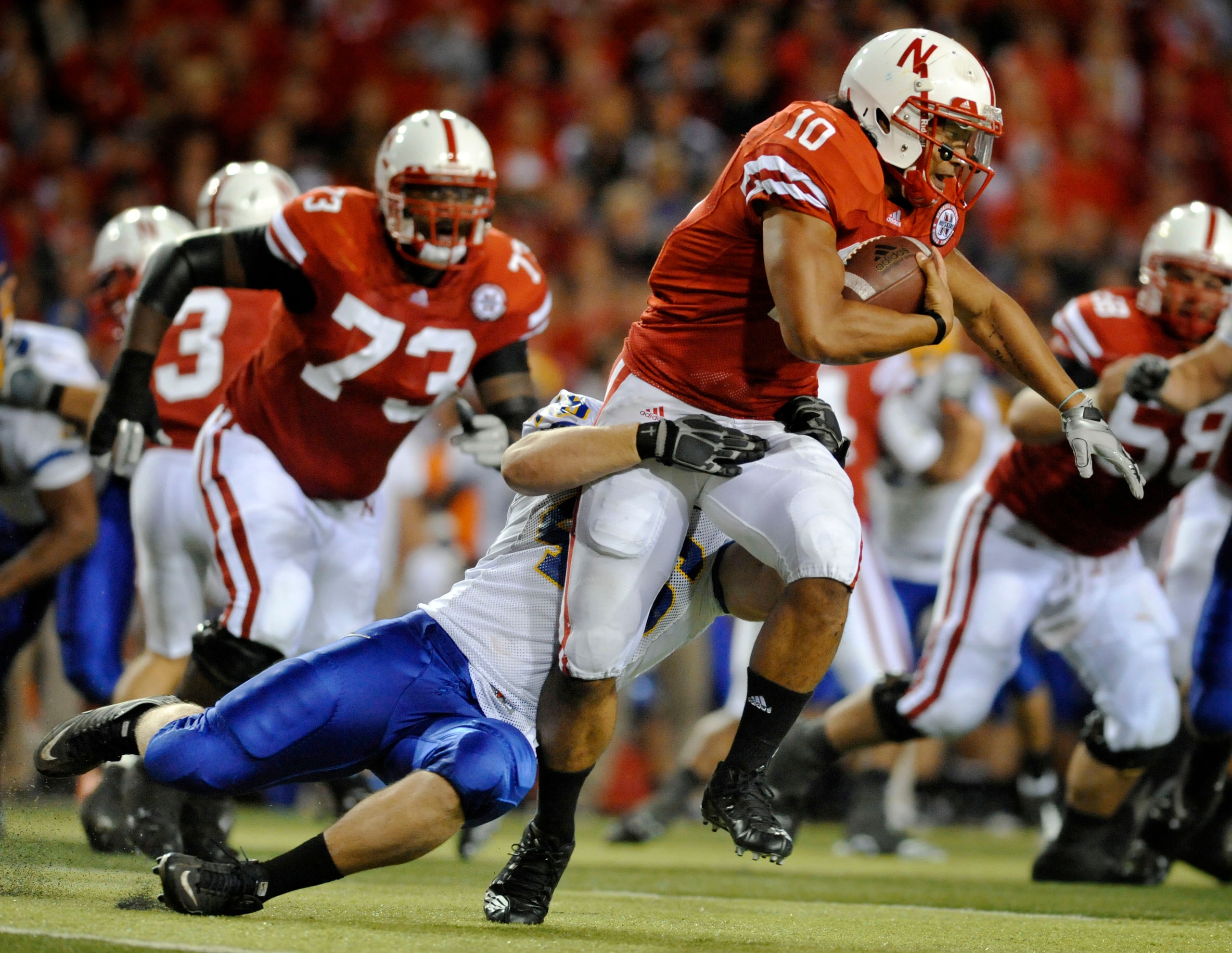 LINCOLN, NE - SEPTEMBER 25: Running back Roy Helu Jr. #10 of the Nebraska Cornuskers tries to slip the grip of defensive tackle Jake Steffen #46 of the South Dakota State Jackrabbits during second half action of their game at Memorial Stadium on September LINCOLN, NE - SEPTEMBER 25: Running back Roy Helu Jr. #10 of the Nebraska Cornuskers tries to slip the grip of defensive tackle Jake Steffen #46 of the South Dakota State Jackrabbits during second half action of their game at Memorial Stadium on September