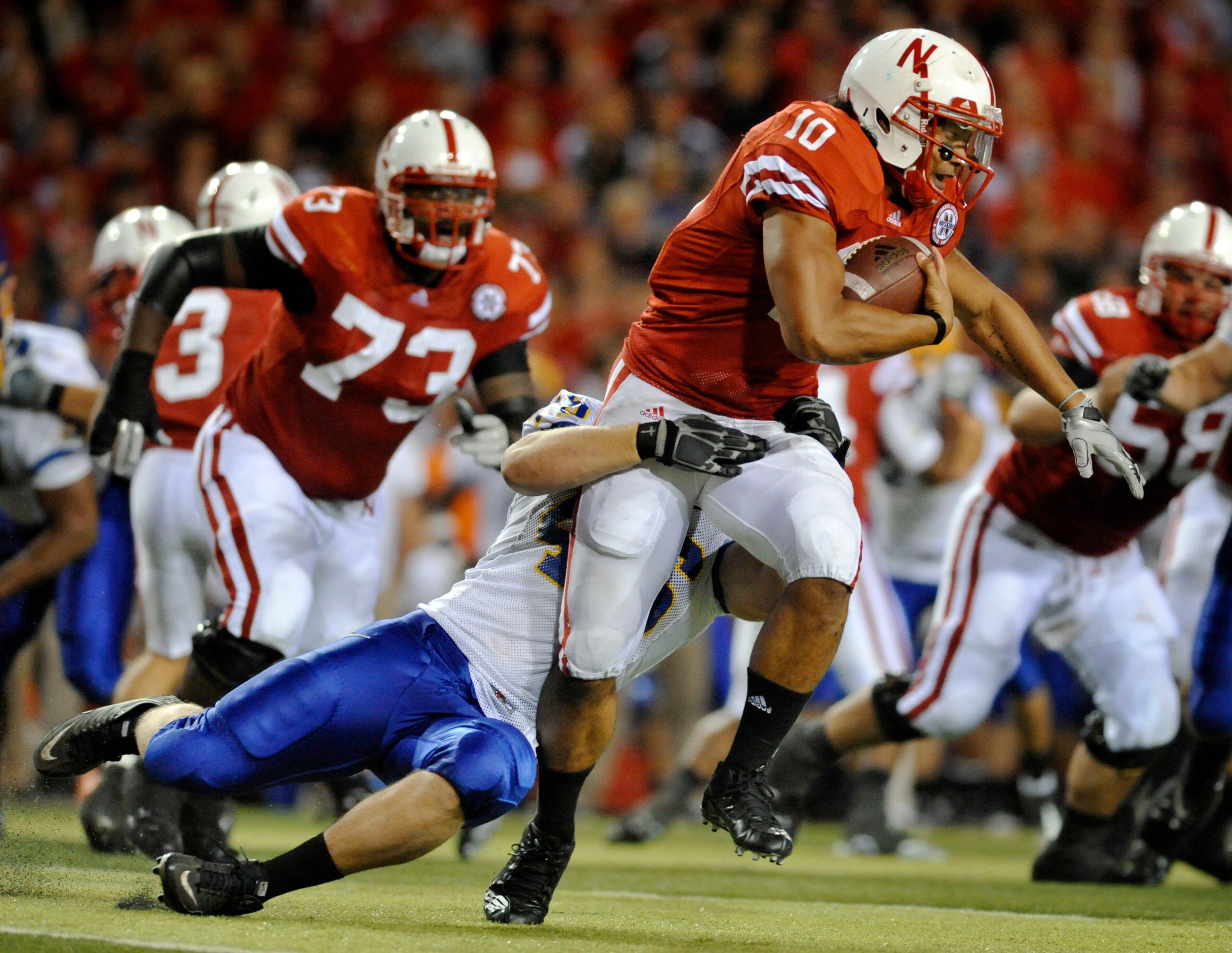 LINCOLN, NE - SEPTEMBER 25: Running back Roy Helu Jr. #10 of the Nebraska Cornuskers tries to slip the grip of defensive tackle Jake Steffen #46 of the South Dakota State Jackrabbits during second half action of their game at Memorial Stadium on September